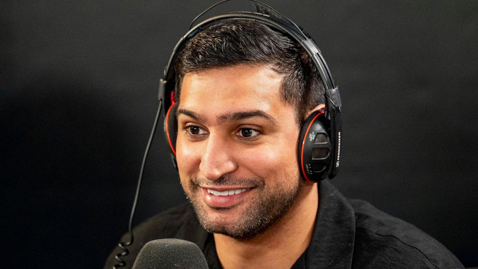 Amir Khan wearing headphones while taking part in a radio interview