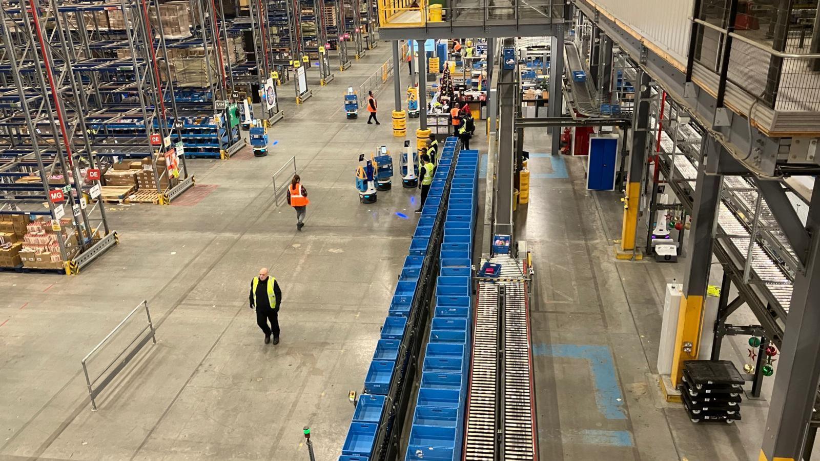 The Boots warehouse from above showing a line of blue crates 