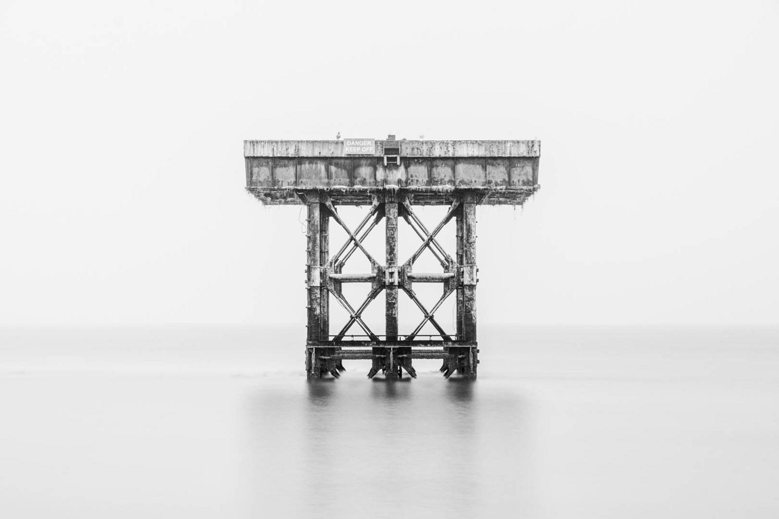 A steel platform stands in a calm sea