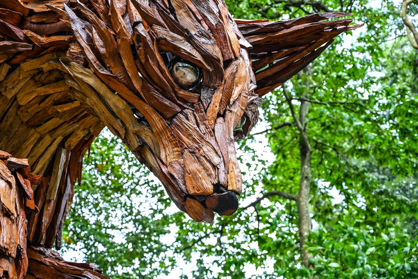 A close up of the fox's face. The eyes are made from metallic balls while the fur is made from spit pieces of rhododendron wood. 