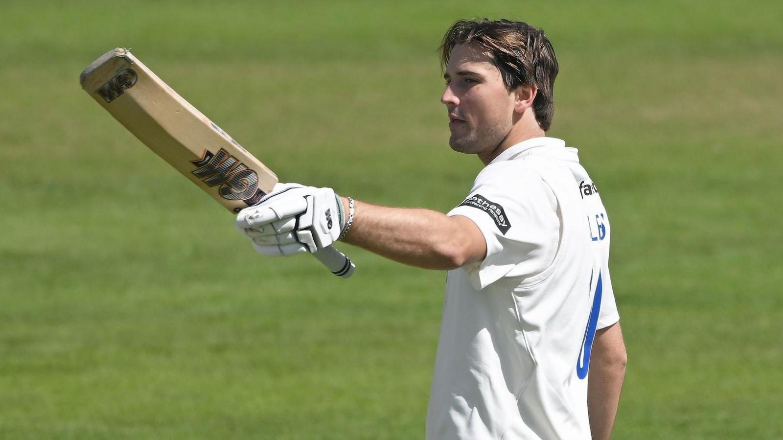 James Coles raises his bat against Glamorgan