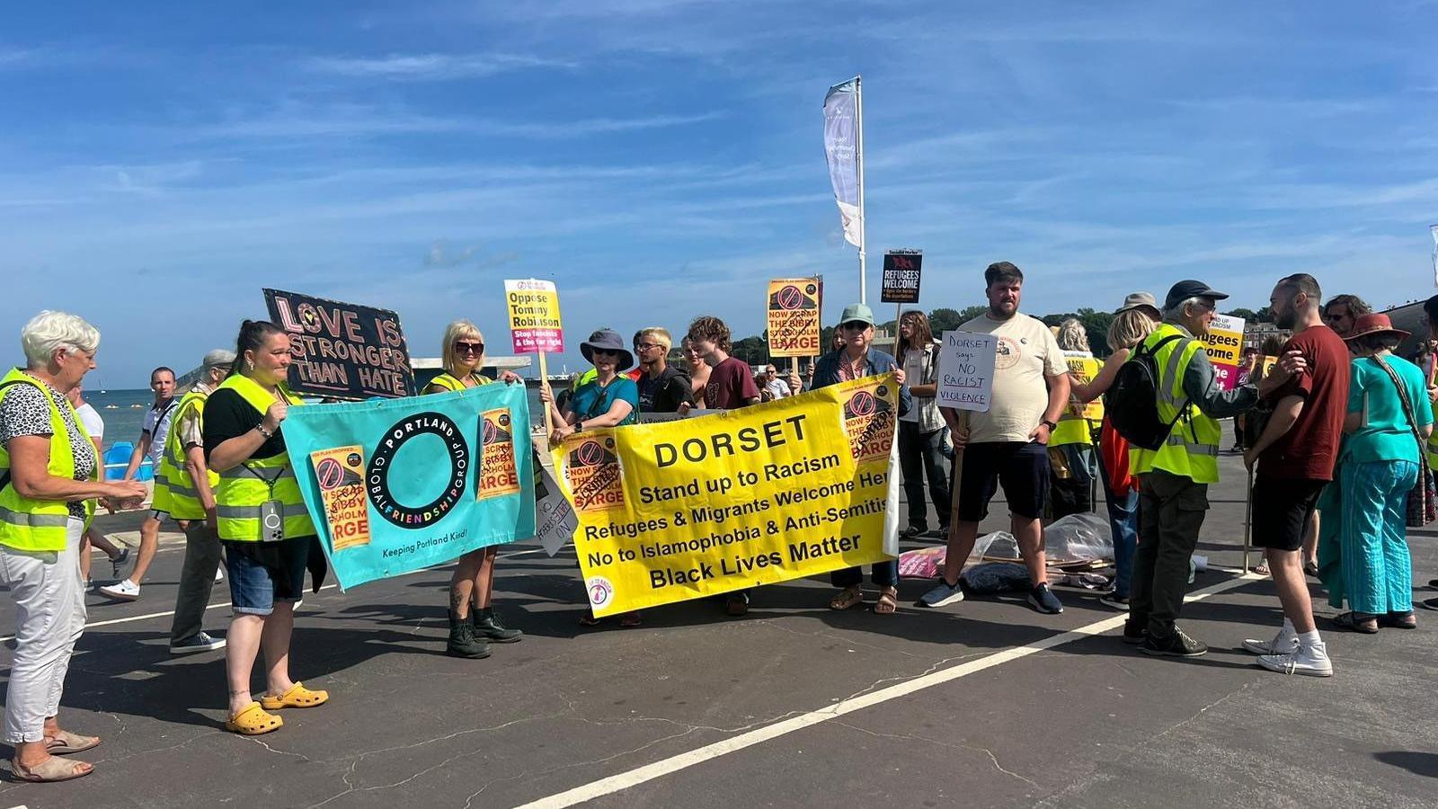 A group of about 20 stand up to racism protesters