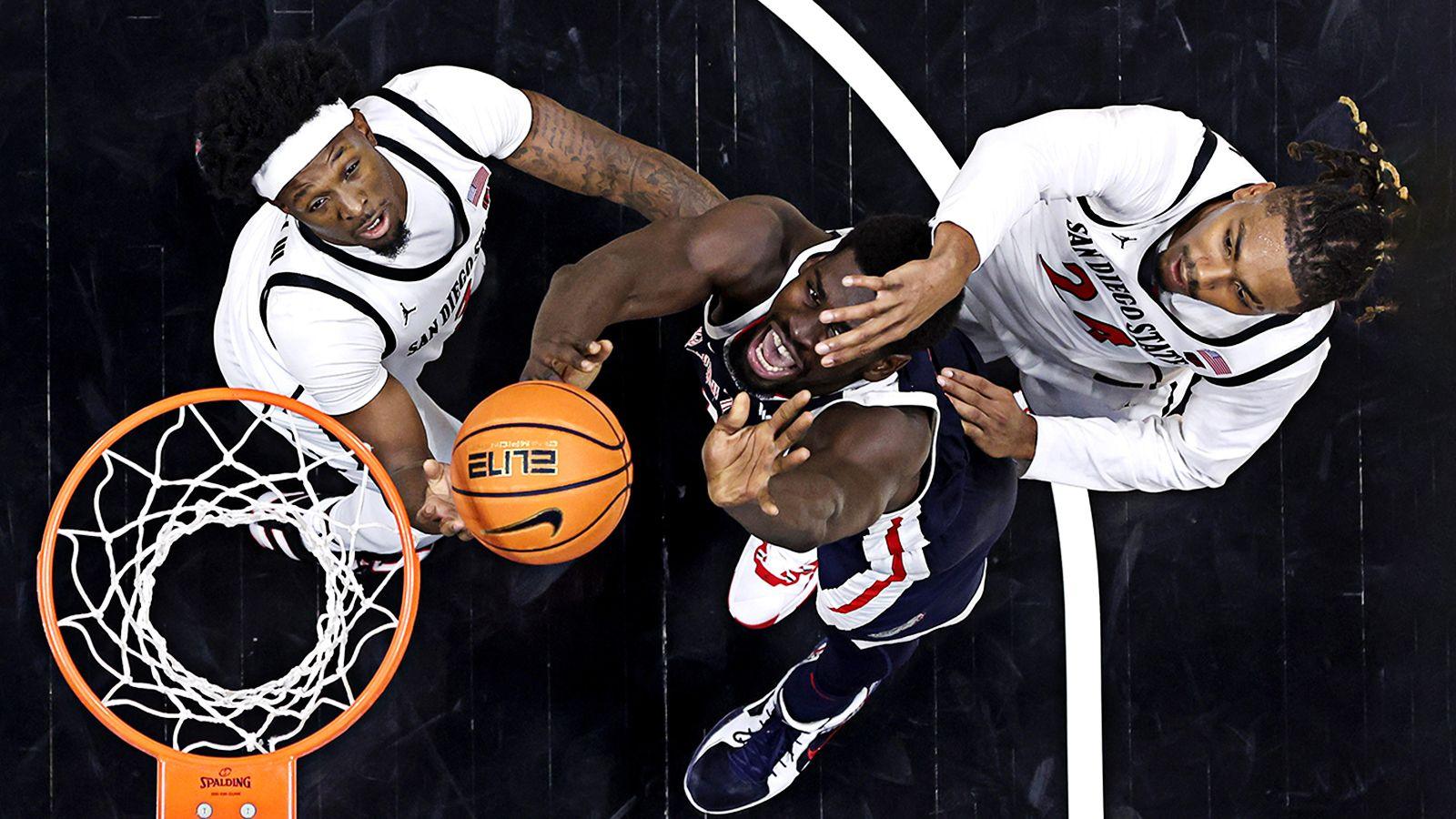 Taj DeGourville and Wayne McKinney III of the San Diego State Aztecs battle Graham Ike from the Gonzaga Bulldogs for a rebound during the second half of a game at Viejas Arena at San Diego State University on 18 November 2024