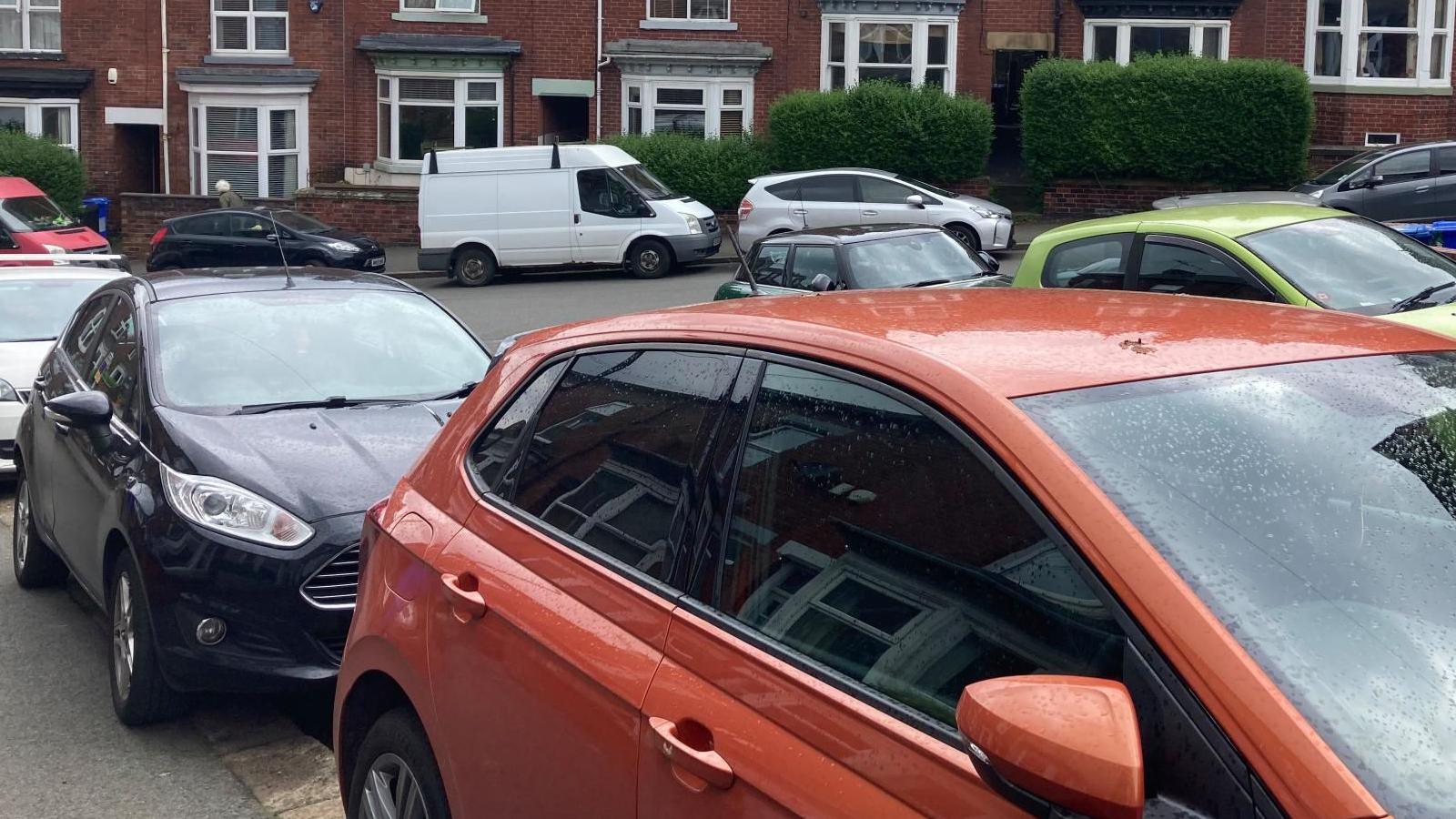 Cars parked on both side of the roads