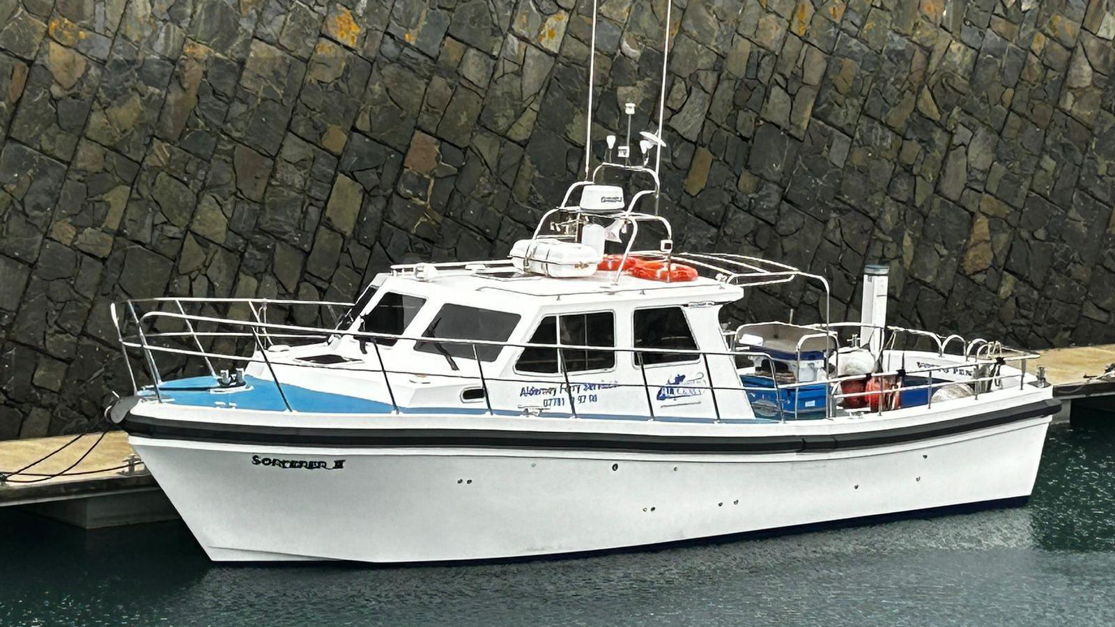 Sorcerer II vessel docked next to a pontoon