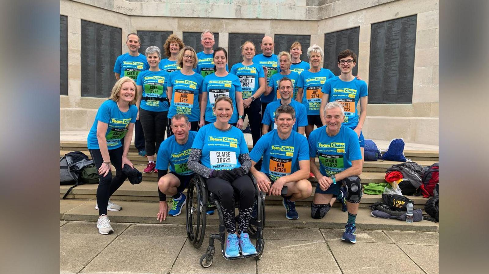 Claire Lomas with friends and family wearing blue tops