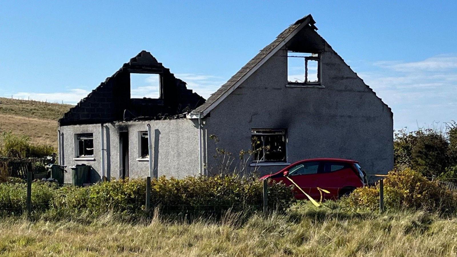 Burned out house where one person died