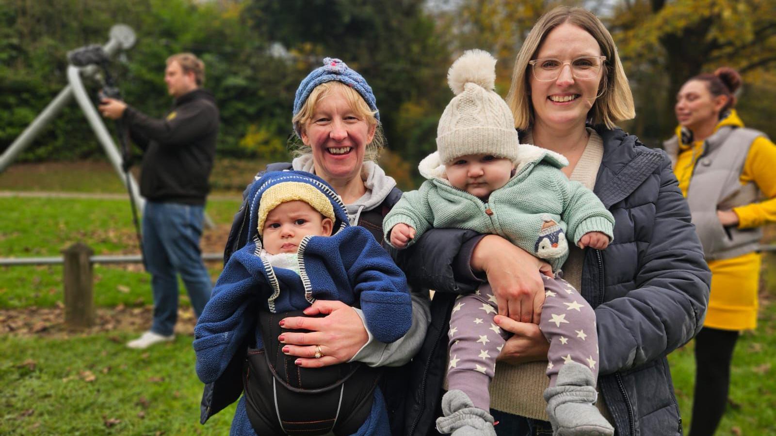 Two mums holding their baby sons