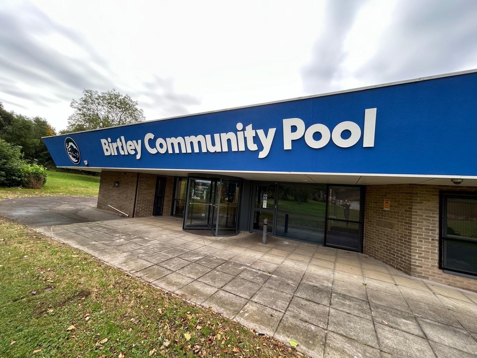 The exterior of the swimming pool. A big blue sign reads 'Birtley Community Pool' above the entrance.