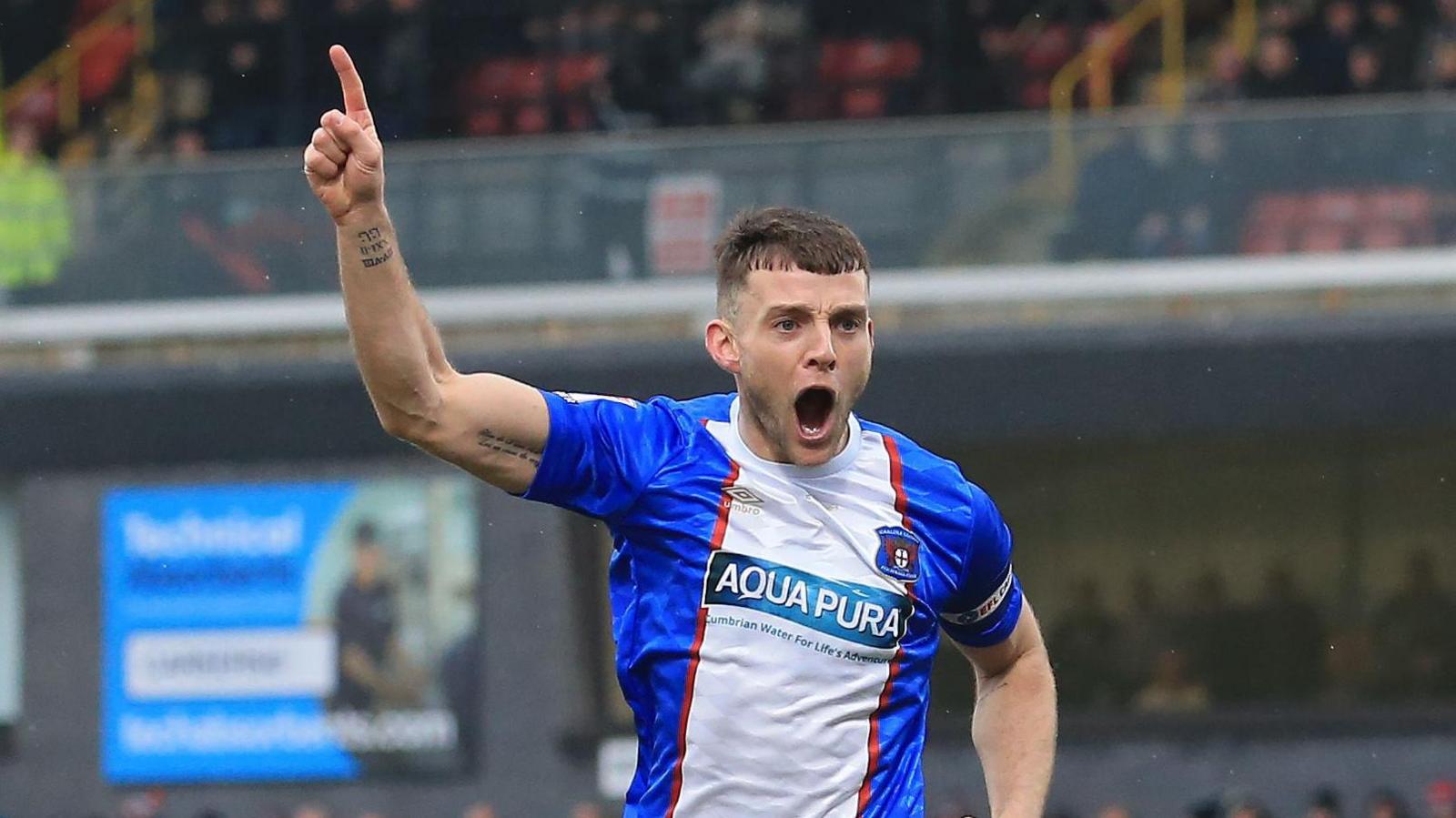 Carlisle-centre back Sam Lavelle celebrates scoring at Grimsby