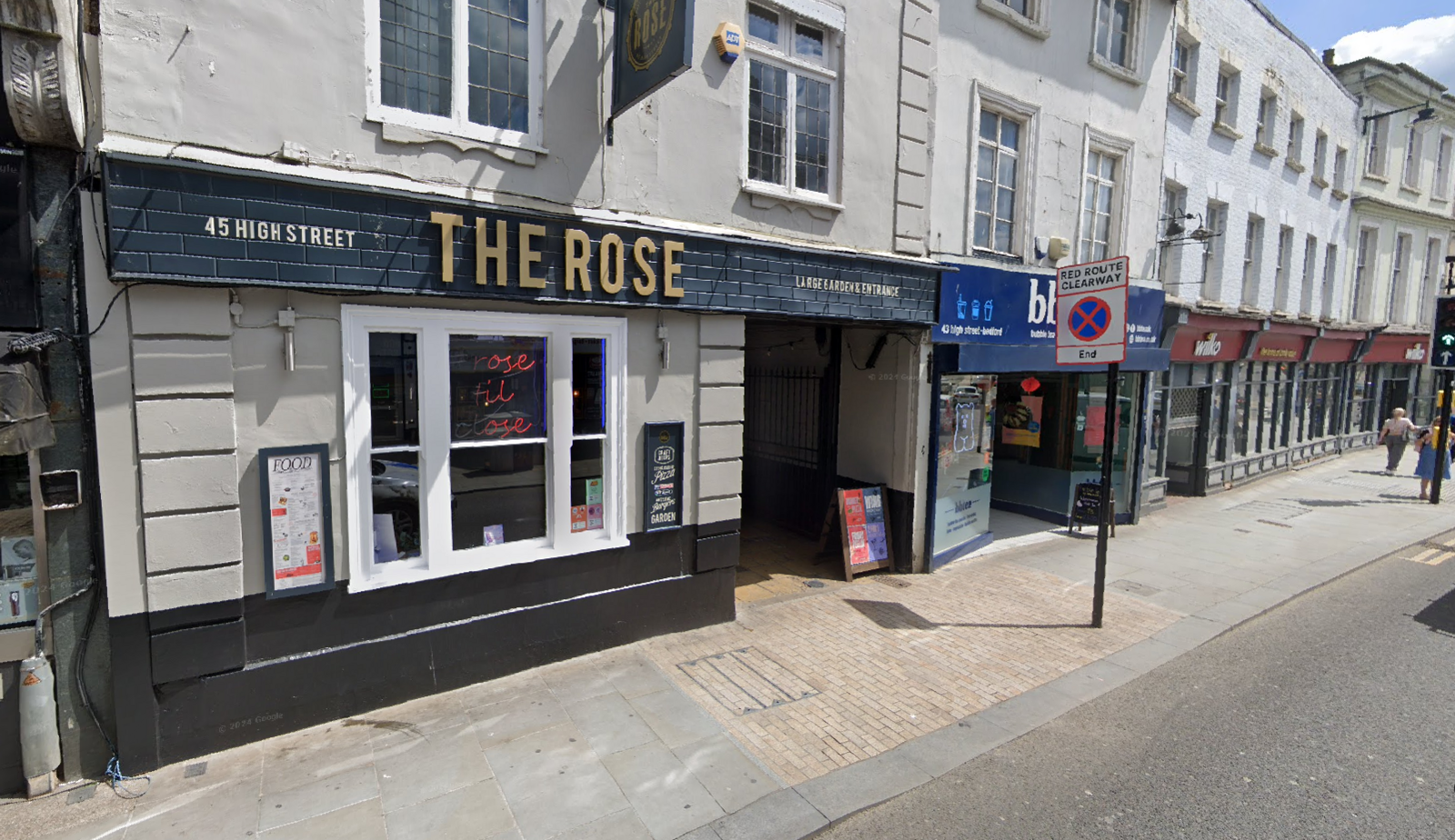 The Rose pub on Bedford High Street on a sunny day