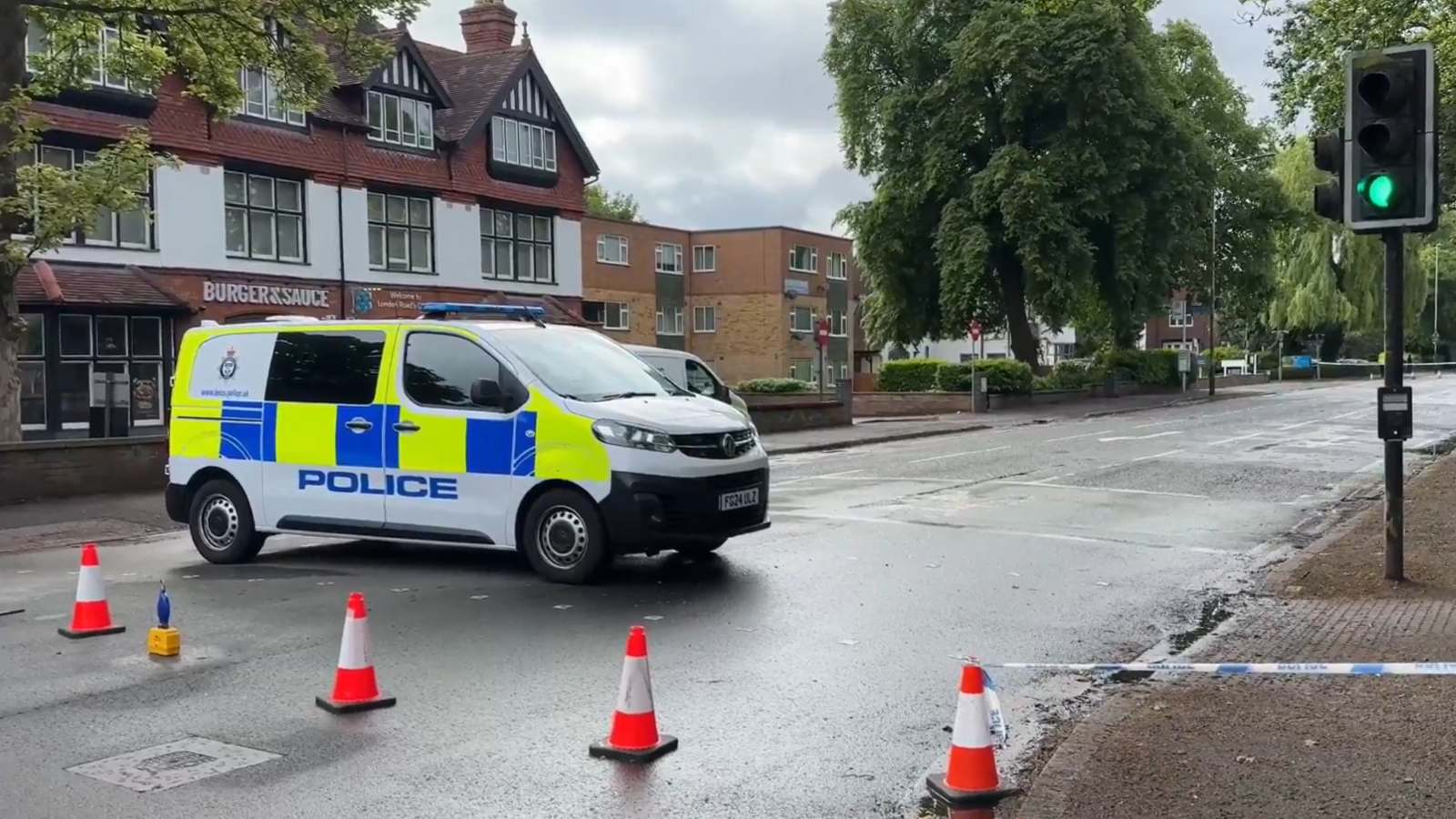 A police van in a coned off road