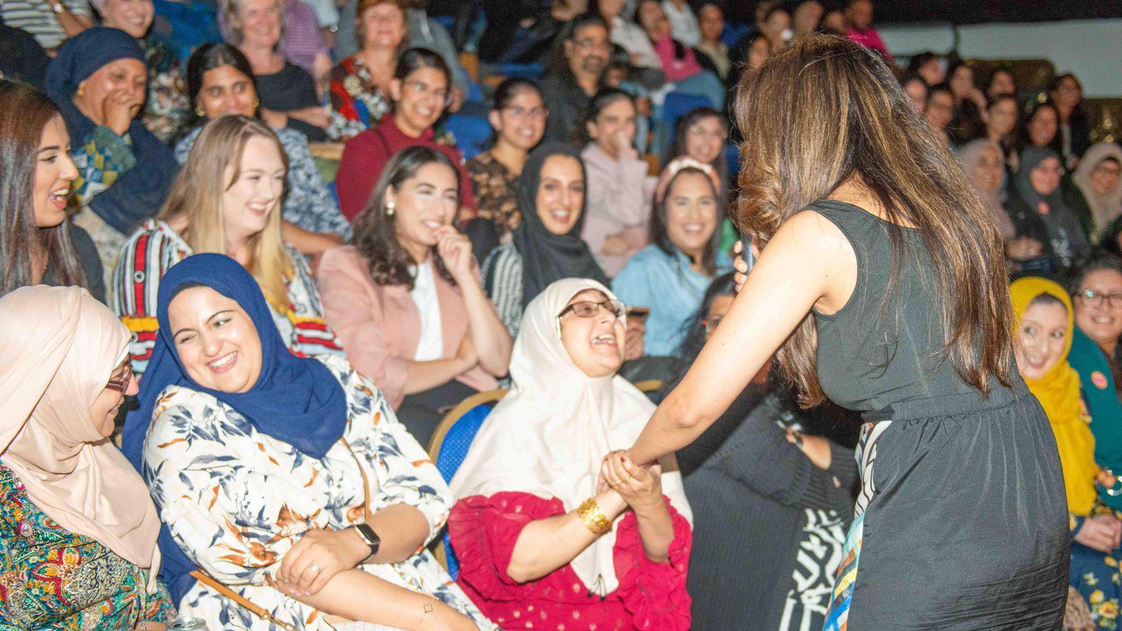 A comedienne shares a laugh with audience members at last year's Gigglewalahs comedy night