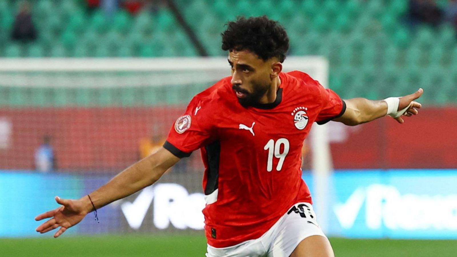 Marwan Attiah spreads his arms out wide as he celebrates a goal for Egypt