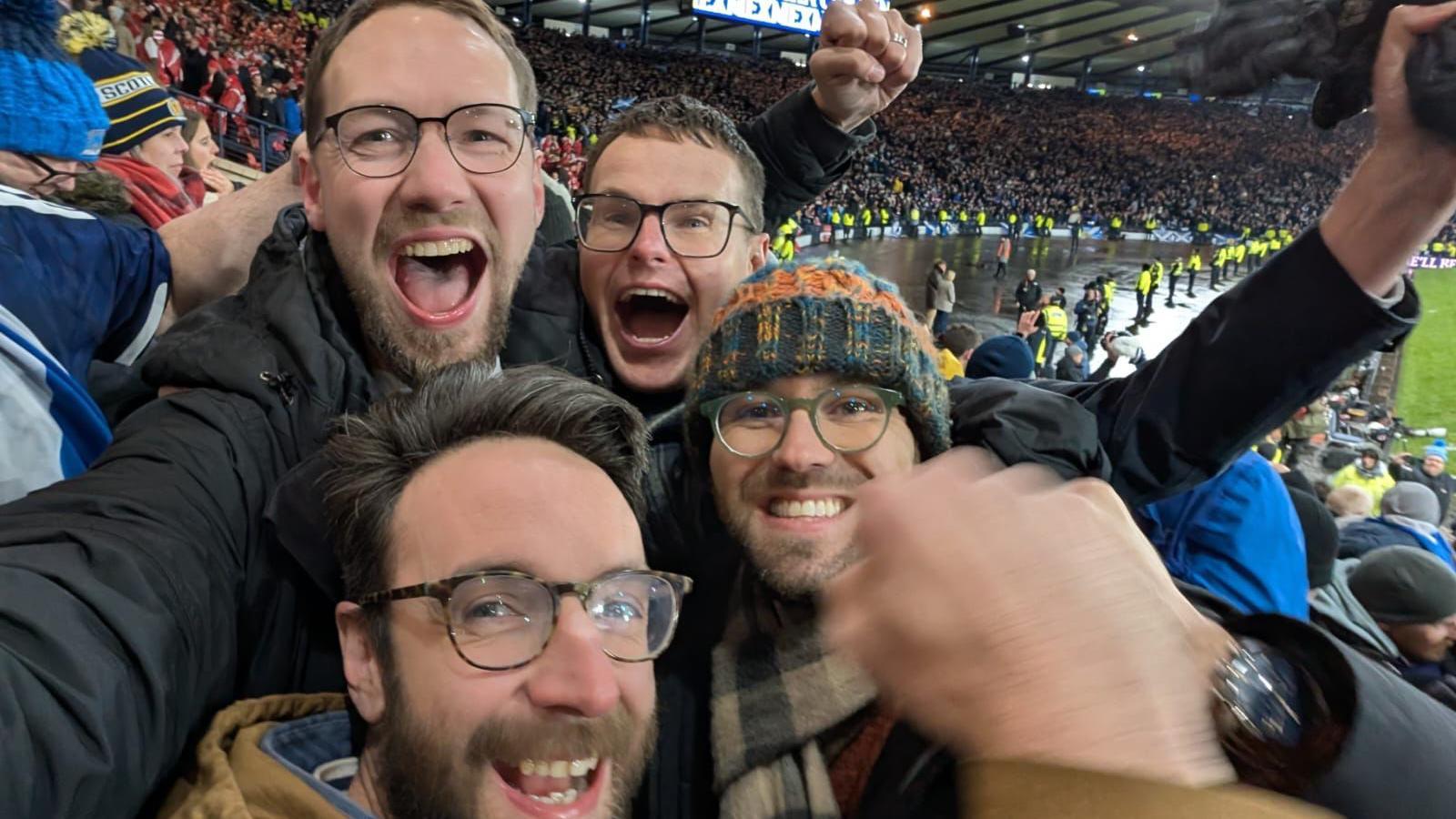 A group of football fans celebrating at Hampden after Scotland's win over Denmark.