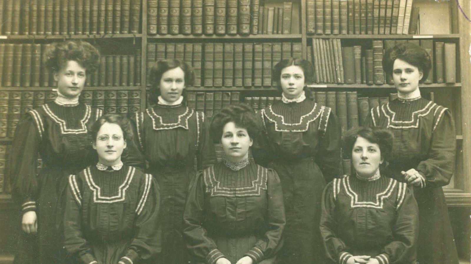 A black and white image of six women in a library in West Sussex. 