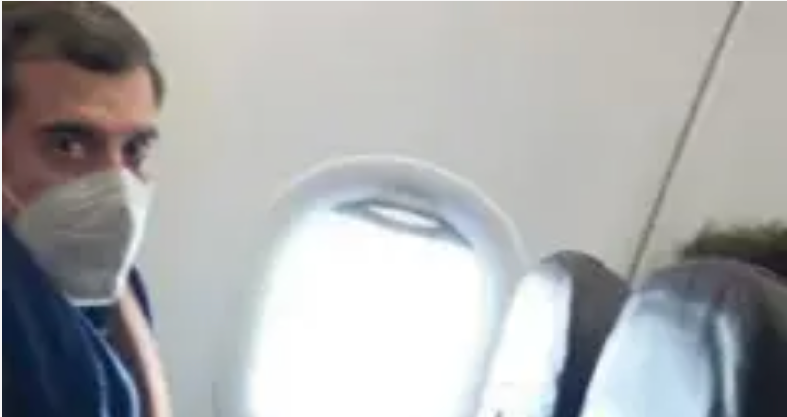 A image of Roman Dobrokhotov onboard a plane and wearing a face mask