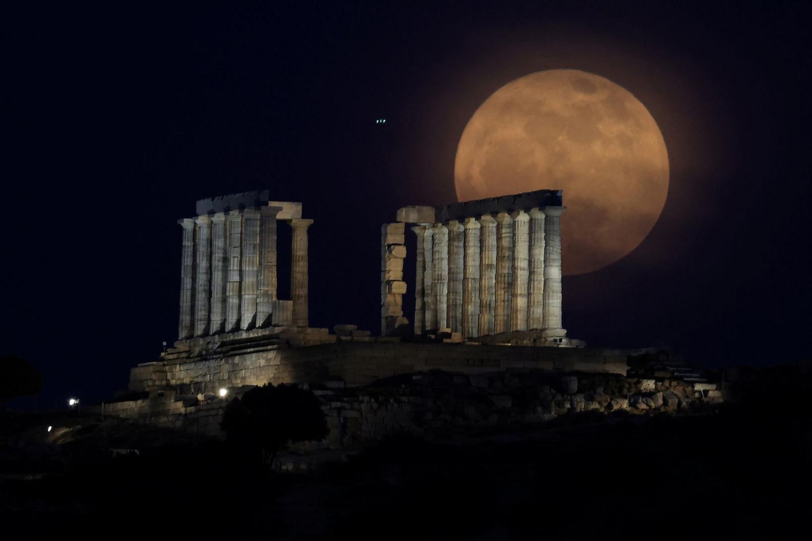 The full moon, known as a "Flower Moon" rises behind the Temple of Poseidon in Cape Sounion, near Athens, Greece, May 12, 2025