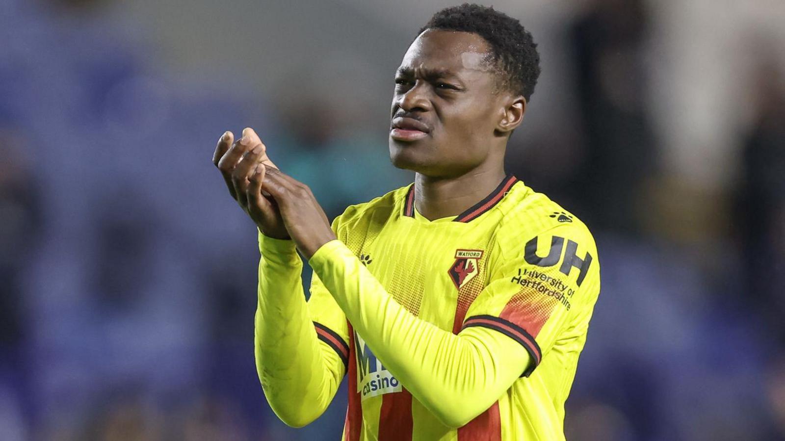 Watford's Marc Bola applauds the away fans