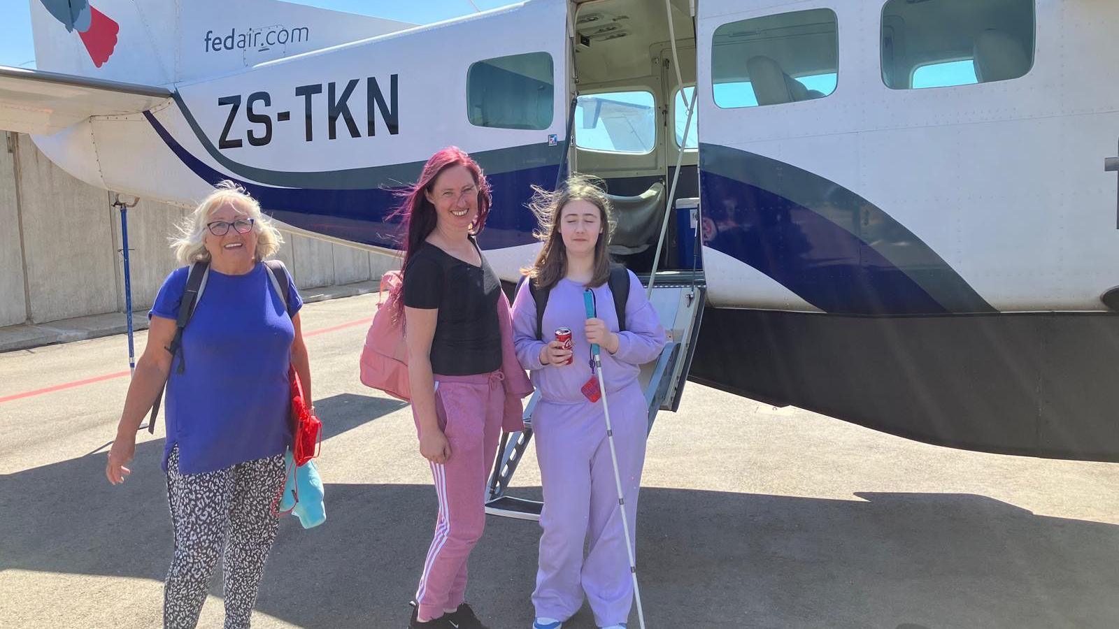 Lily-Rae pictured with her mum Emma who is in the middle, and grandmother Lesley on the right. They are boarding on a plane in South Africa. 