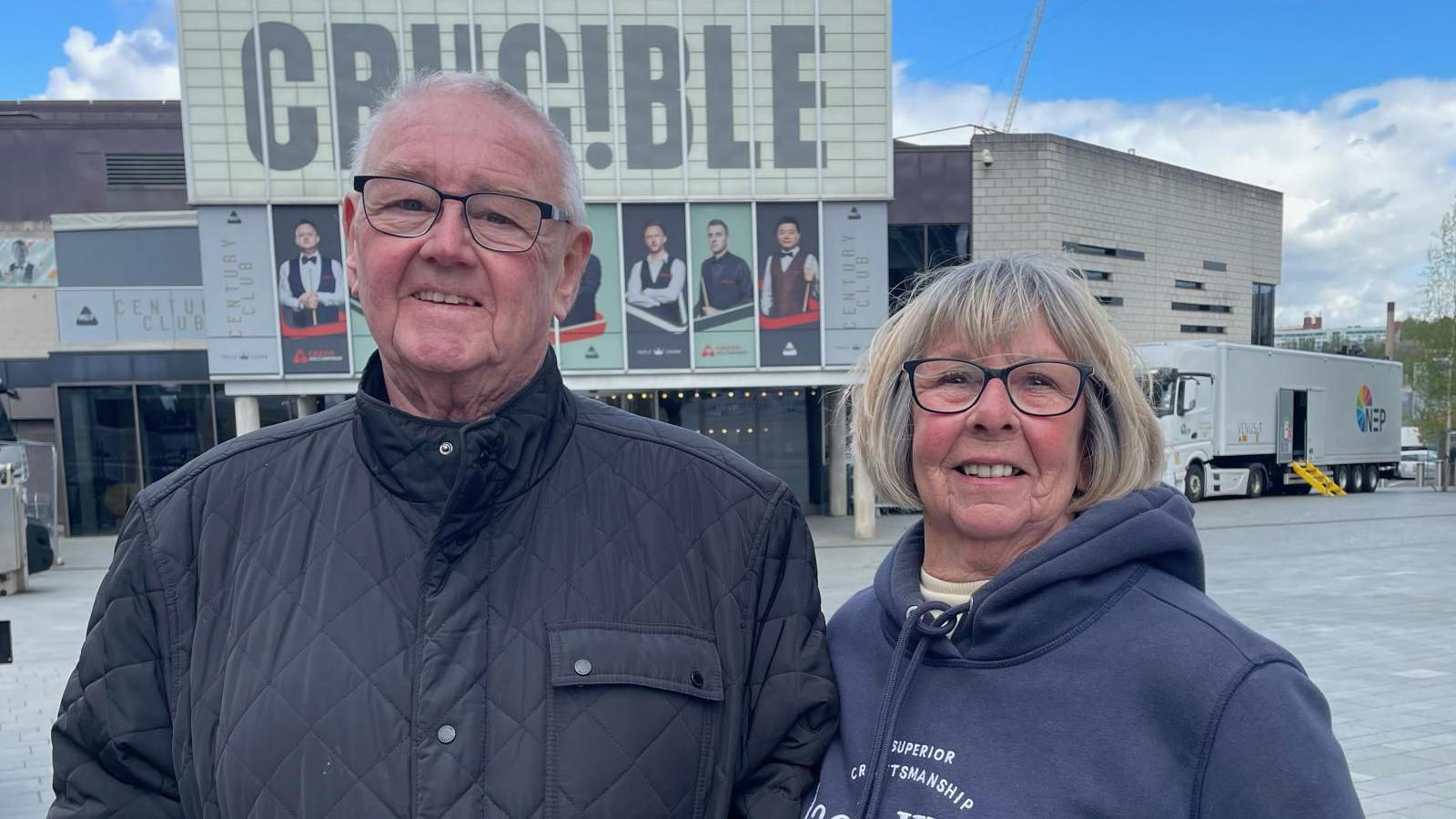 A man and women stand together outside the Crucible Theatre