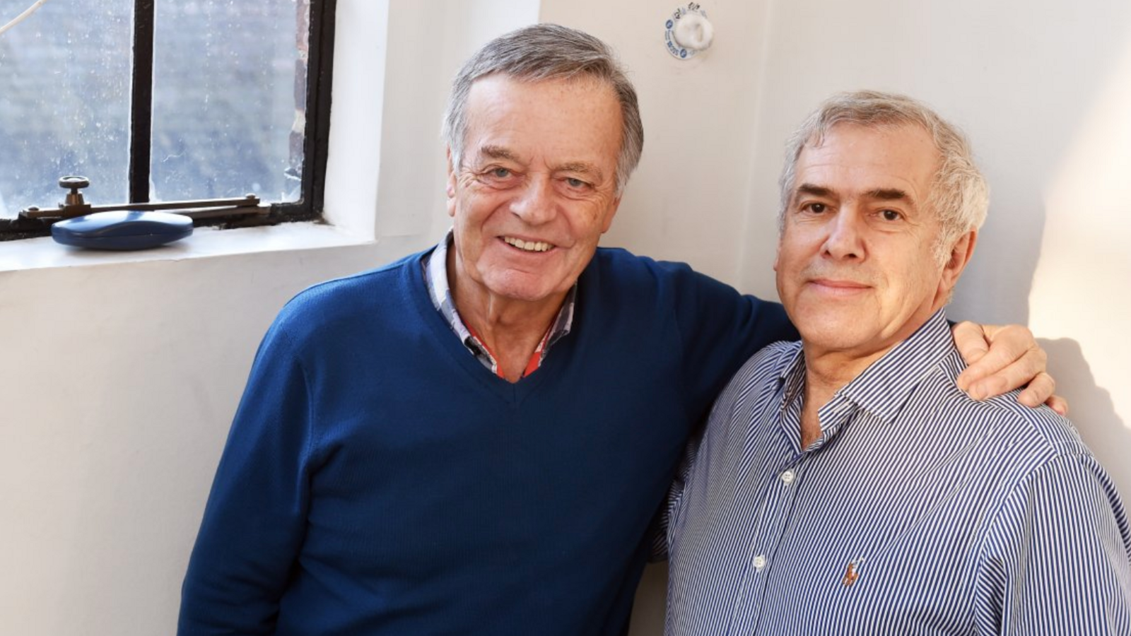 Tony Blackburn pictured in December 2017 in a BBC building with his arm around Phil Swern