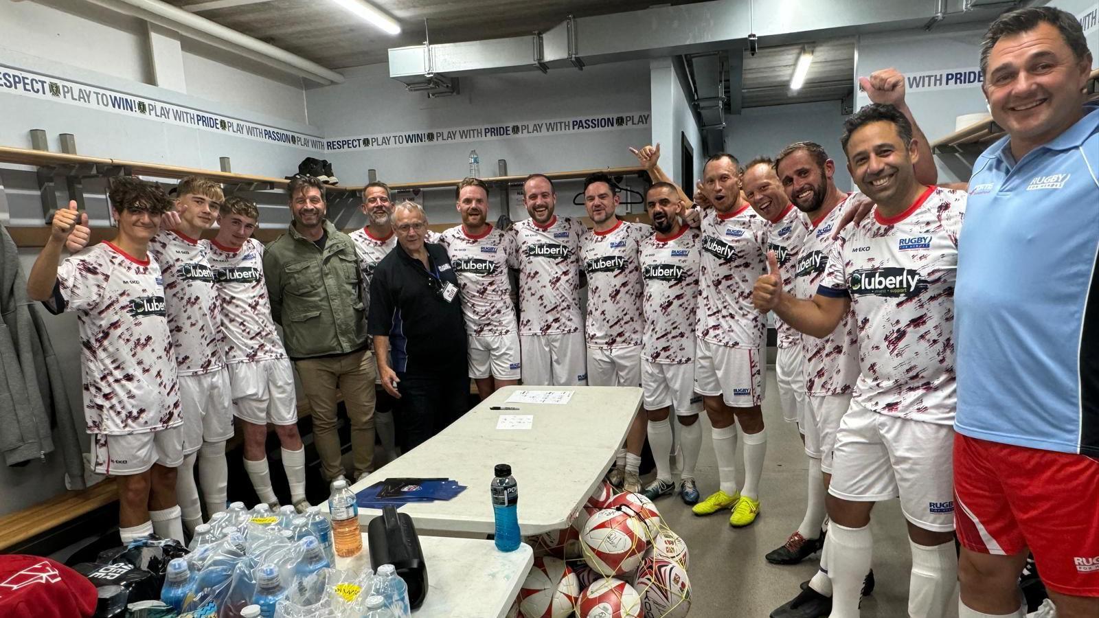 Group of men in changing room in matching football kit