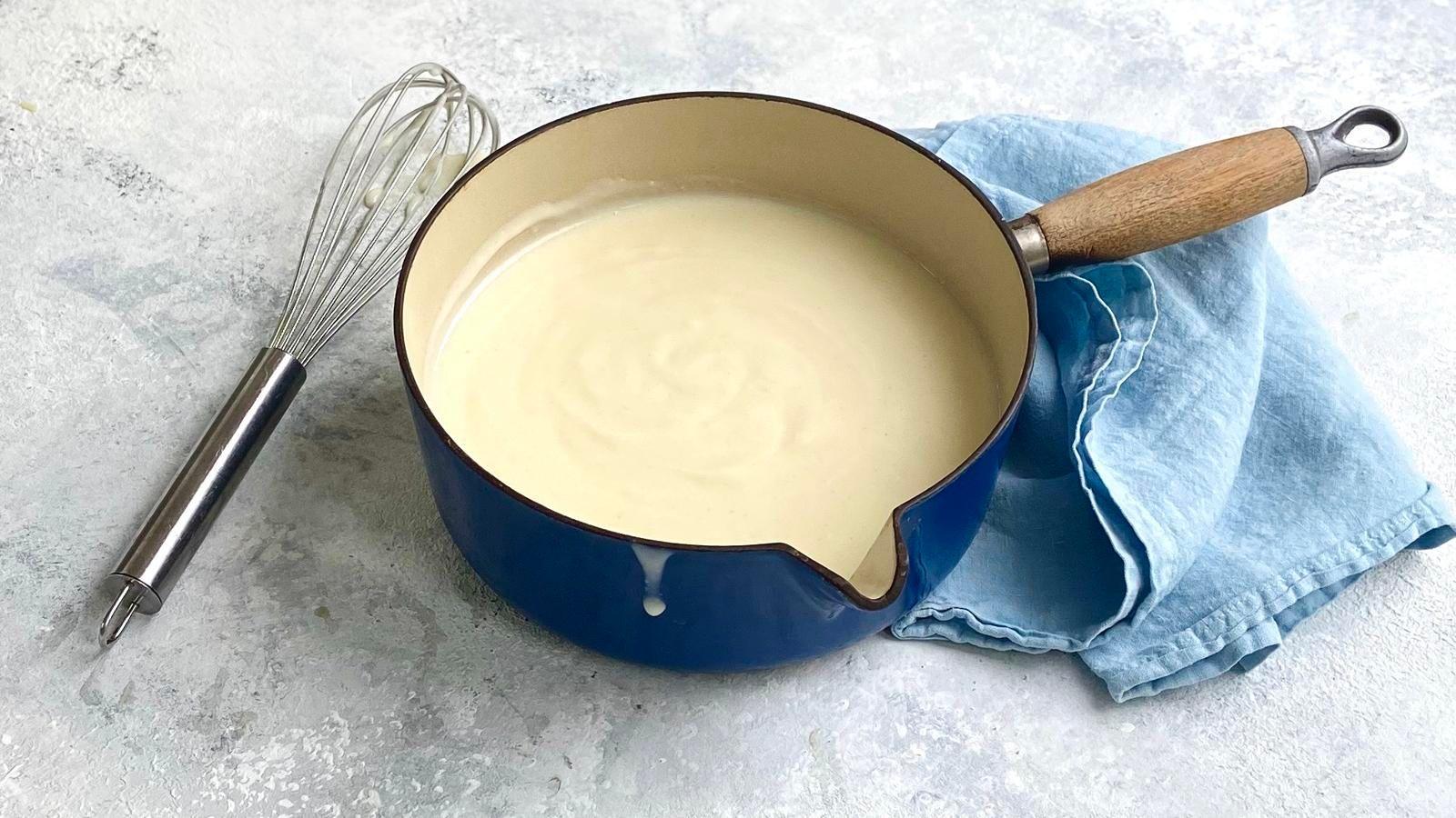 White sauce in a blue sauce pan
