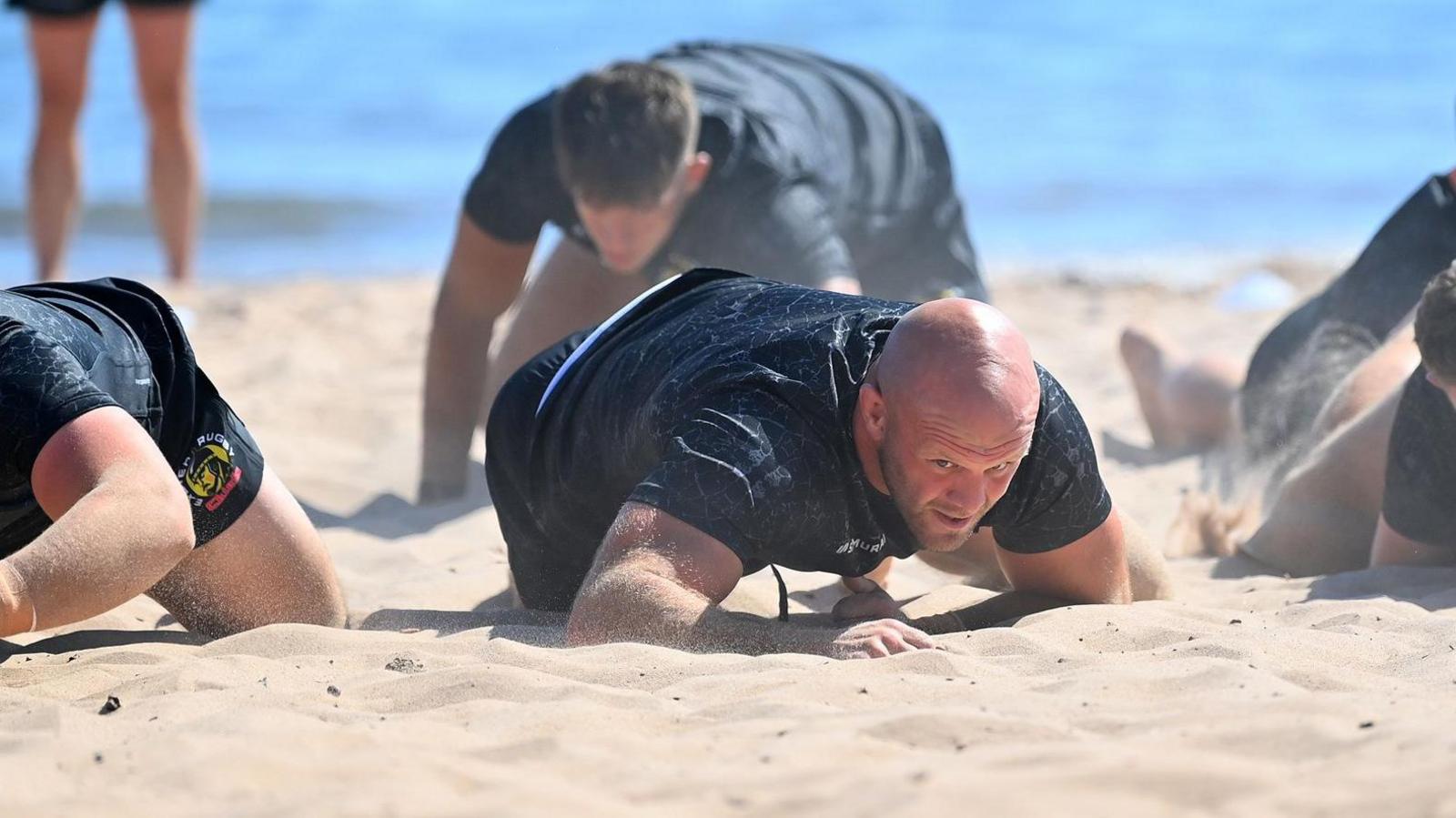 Jack Yeandle crawls up the beach