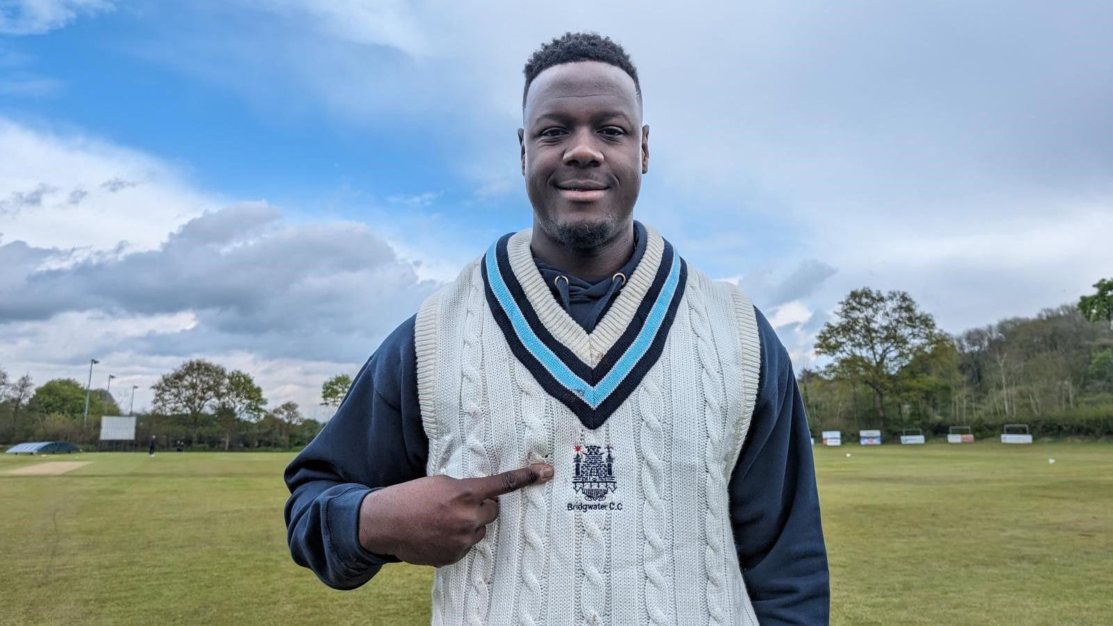 Carlos Brathwaite points to his Bridgwater CC badge