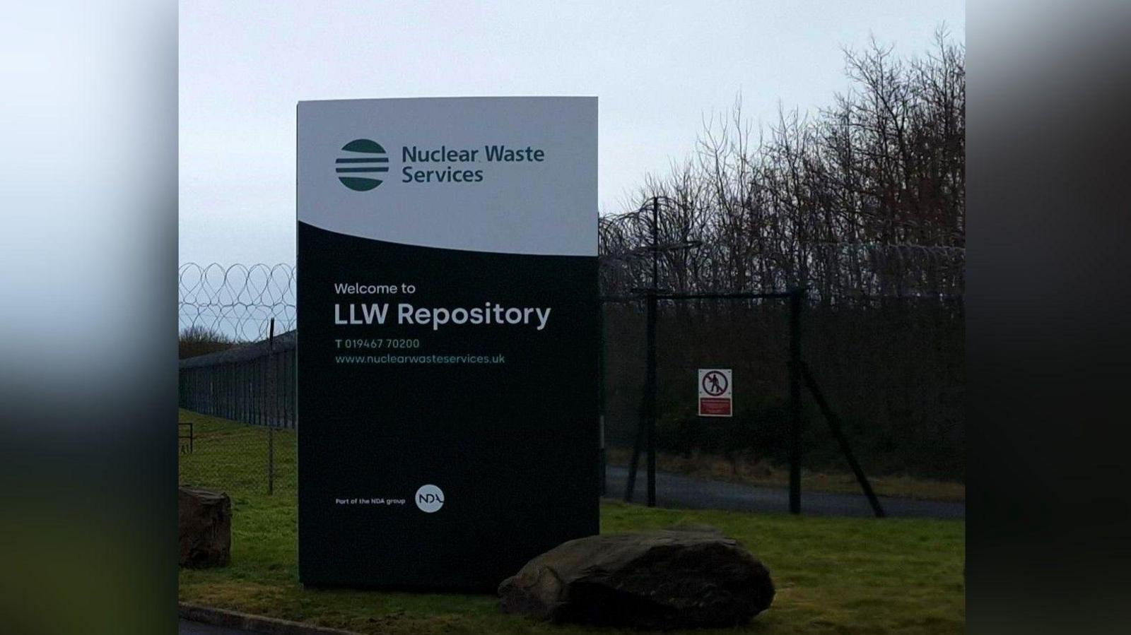 A general view of the entrance to the LLWR site with a sign saying "Welcome to LLW Repository"