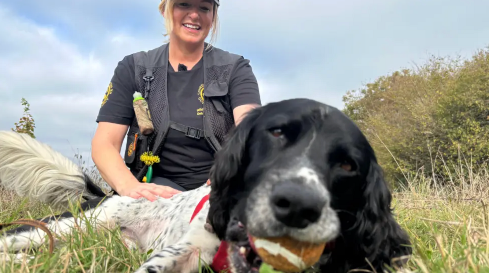 Henry the dog lying on the ground next to owner Louise.
