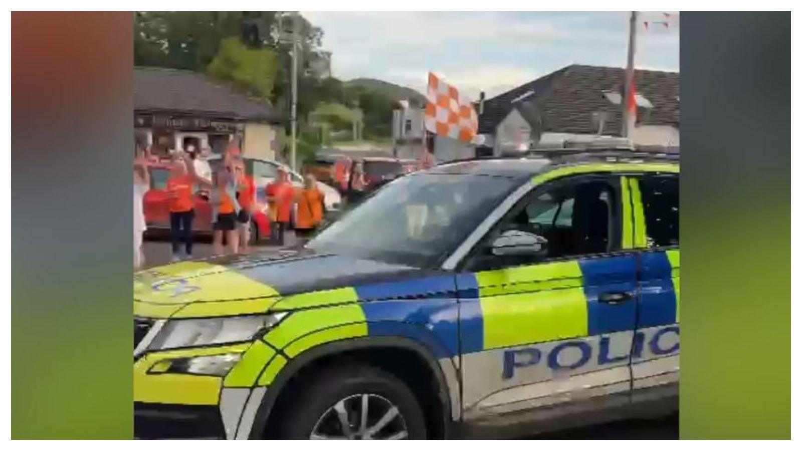 PSNI car with officer holding Armagh flag