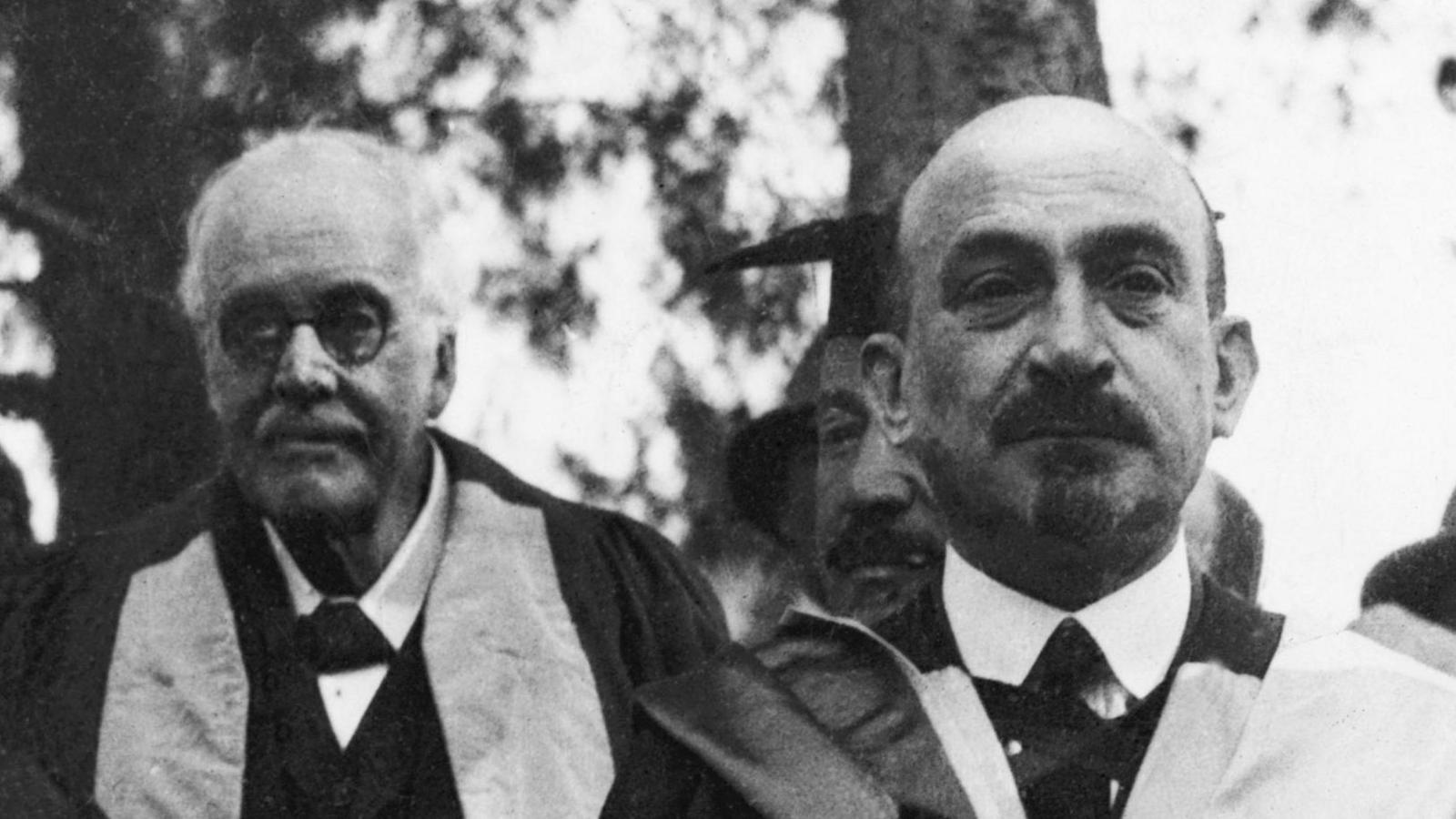 Black and white image of Lord Balfour and Chaim Weizmann in honorary academic gowns at an event