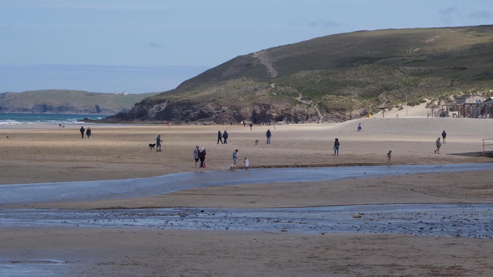 Beach in Cornwall people walking