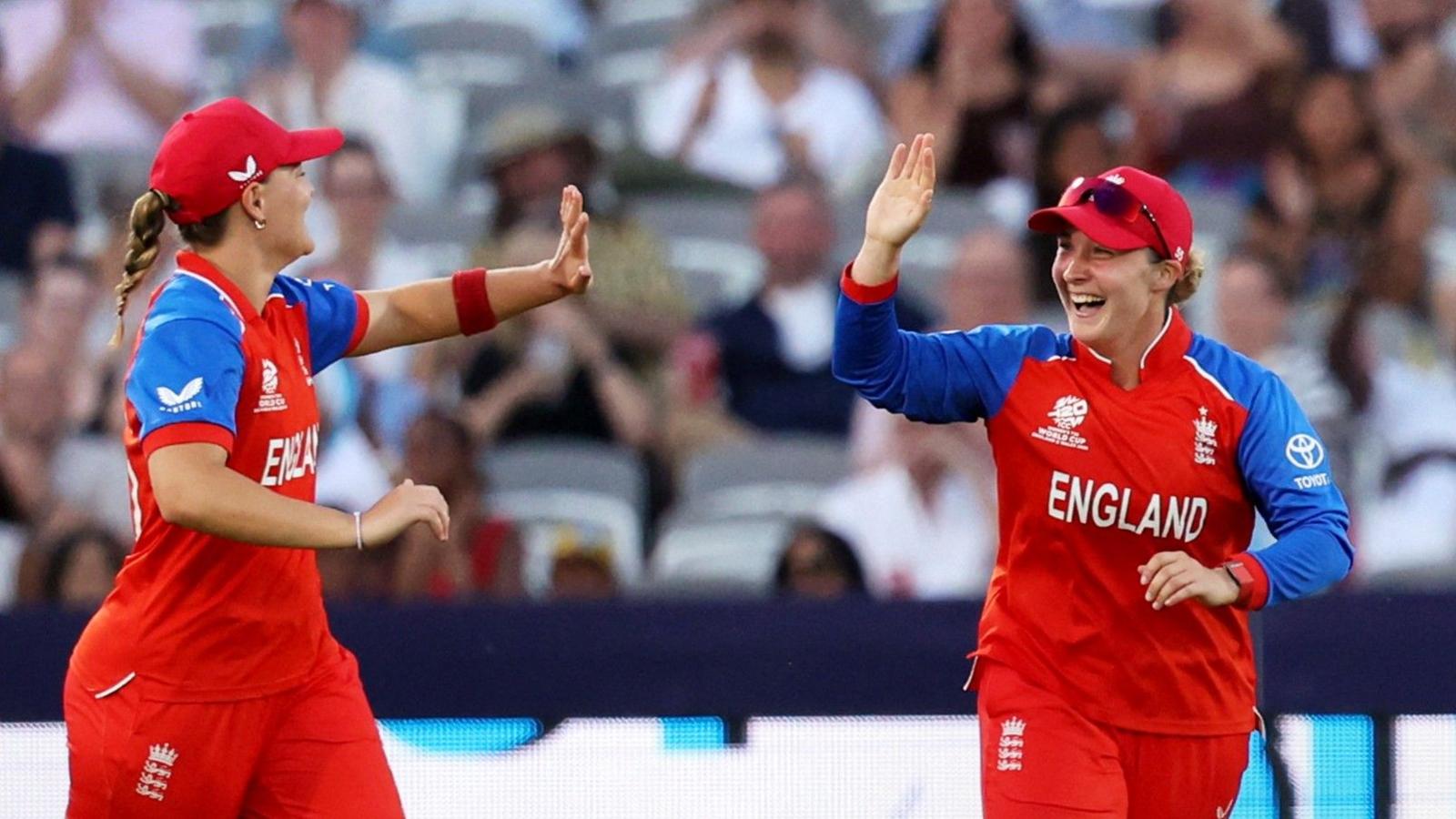 Dani Gibson and Alice Capsey celebrate a wicket with a high five