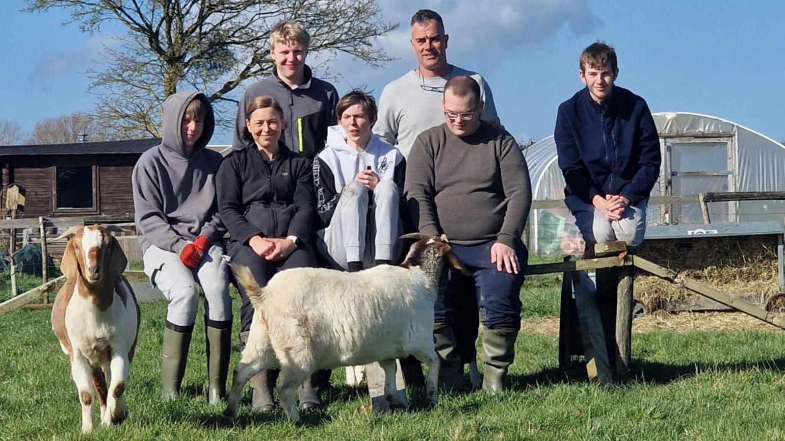 Tas Stamatopoulos and Jacqueline Stamatopoulos with some of their students and two goats