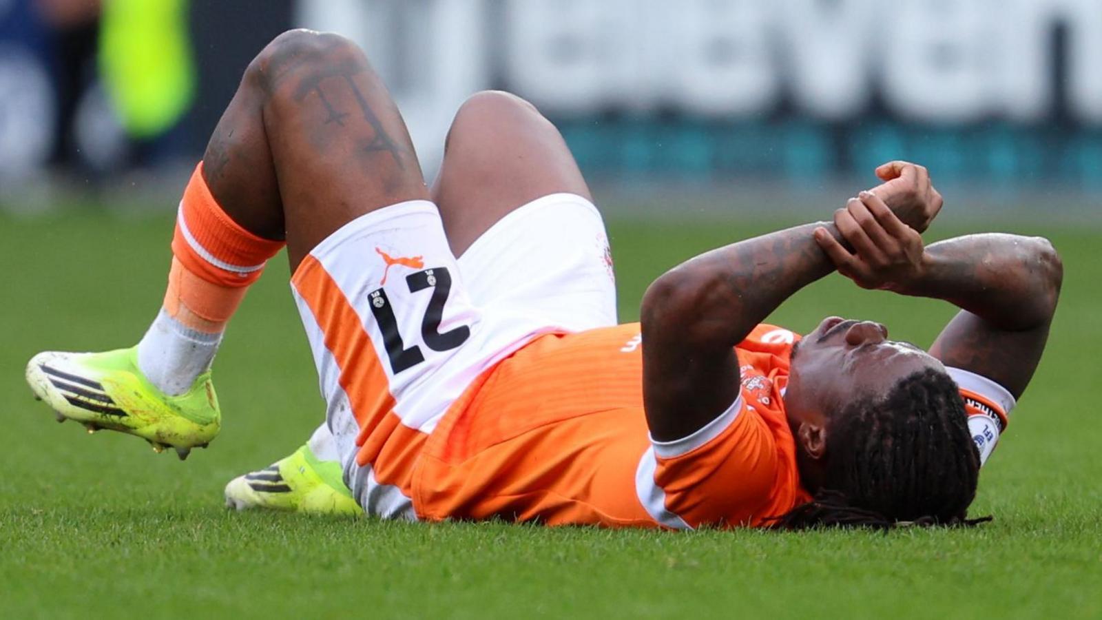 Michael Obafemi lies on the turf injured during the match against Plymouth