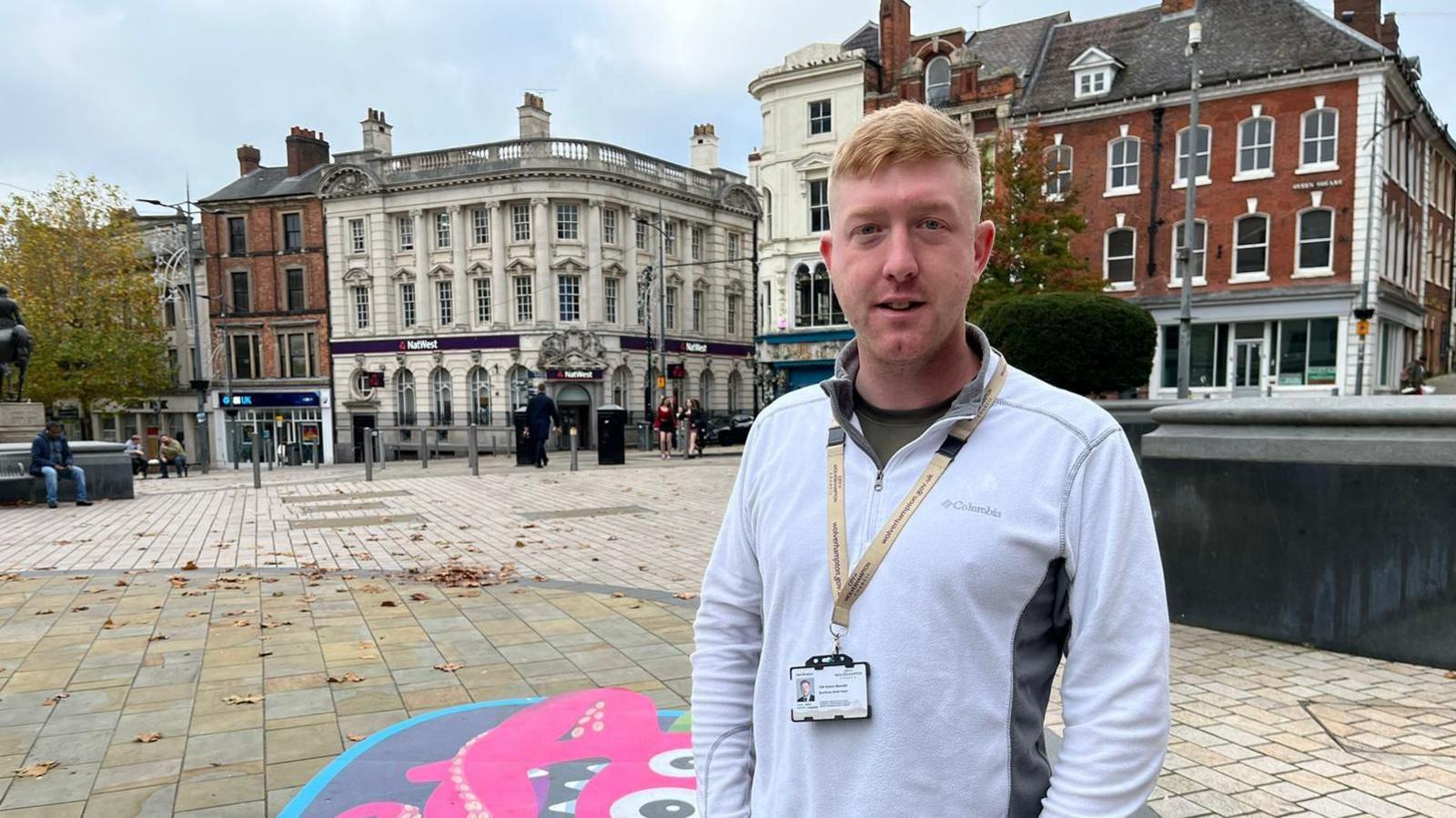 Councillor Simon Bennett stands in Wolverhampton high street, with buildings in the background