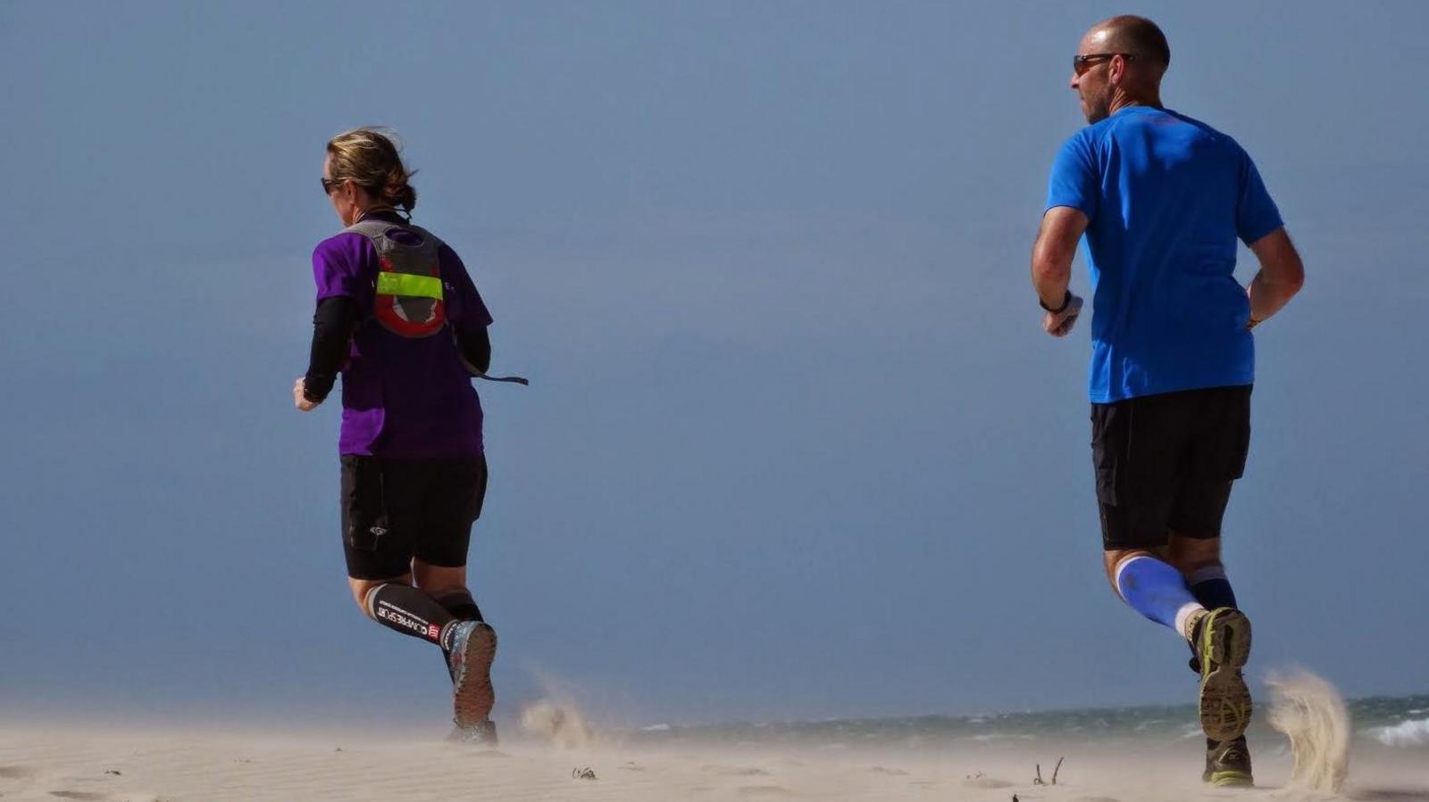 People run on a beach