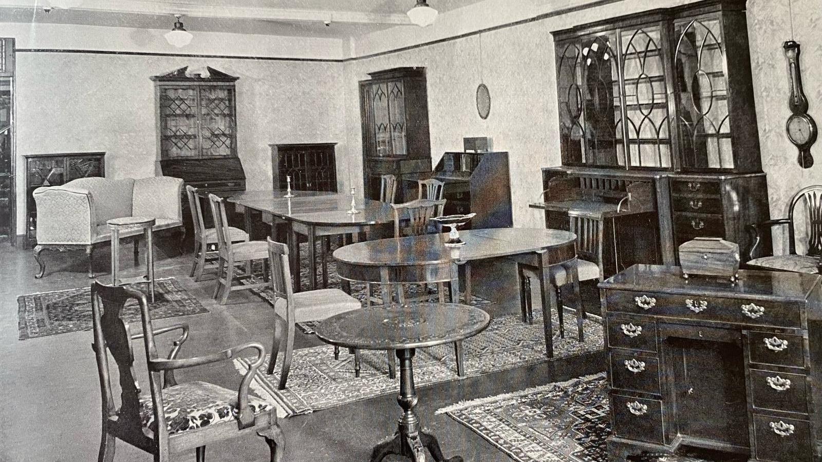 A black and white photo showing various bits of furniture.