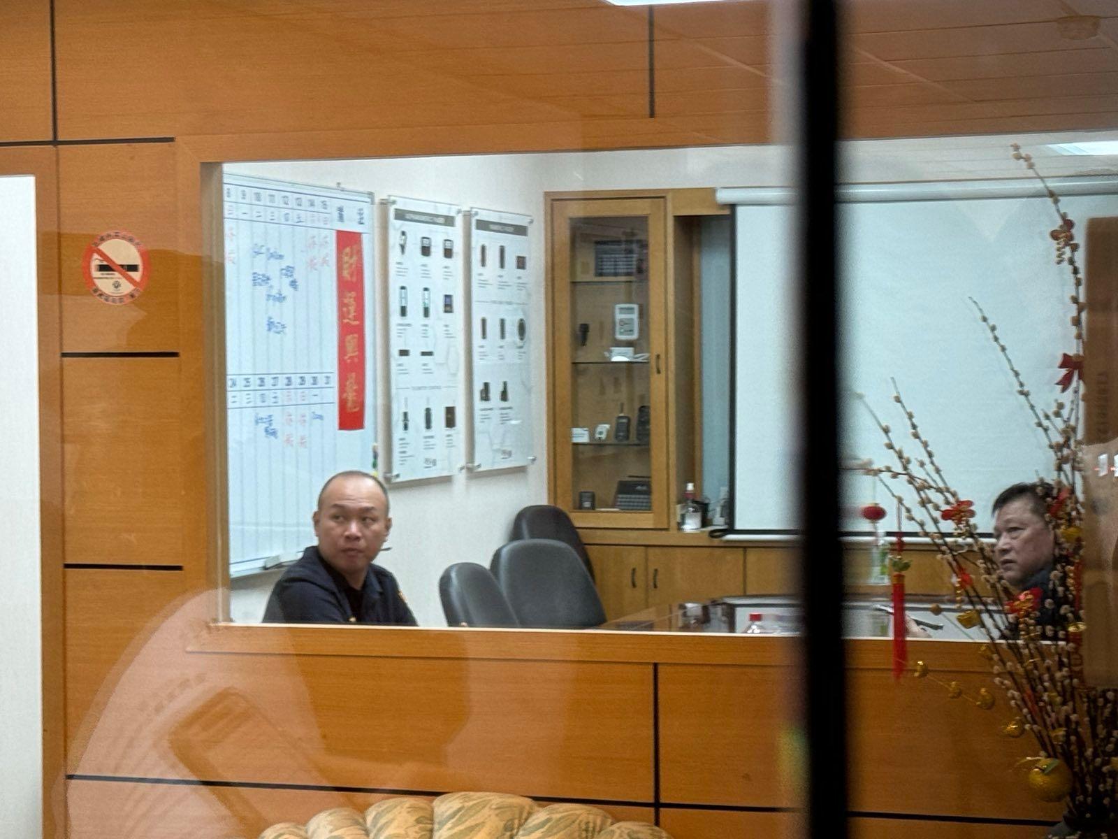 Police officers inside the offices of Gold Apollo in Taipei.  