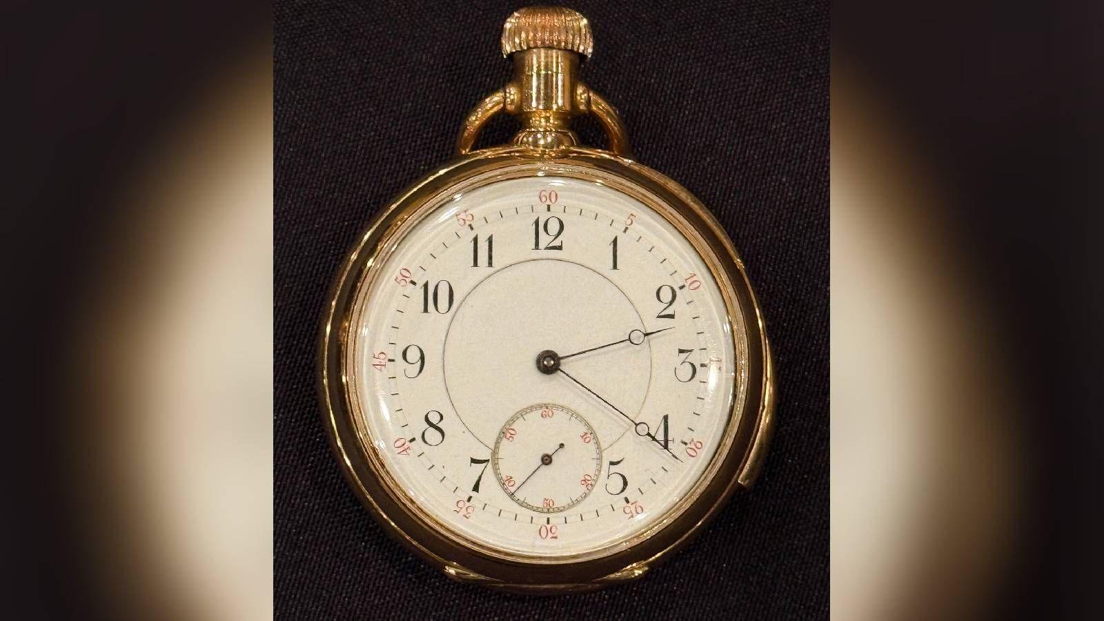 The pocket watch face which is stuck on the time 2:20am.