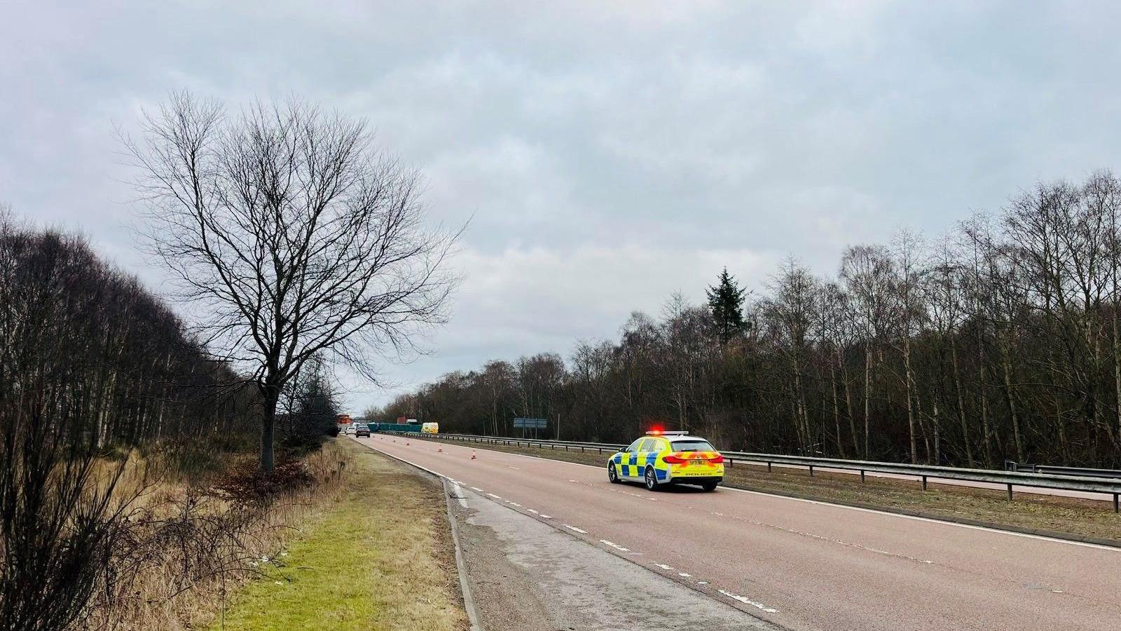 Police car on a dual carriageway.