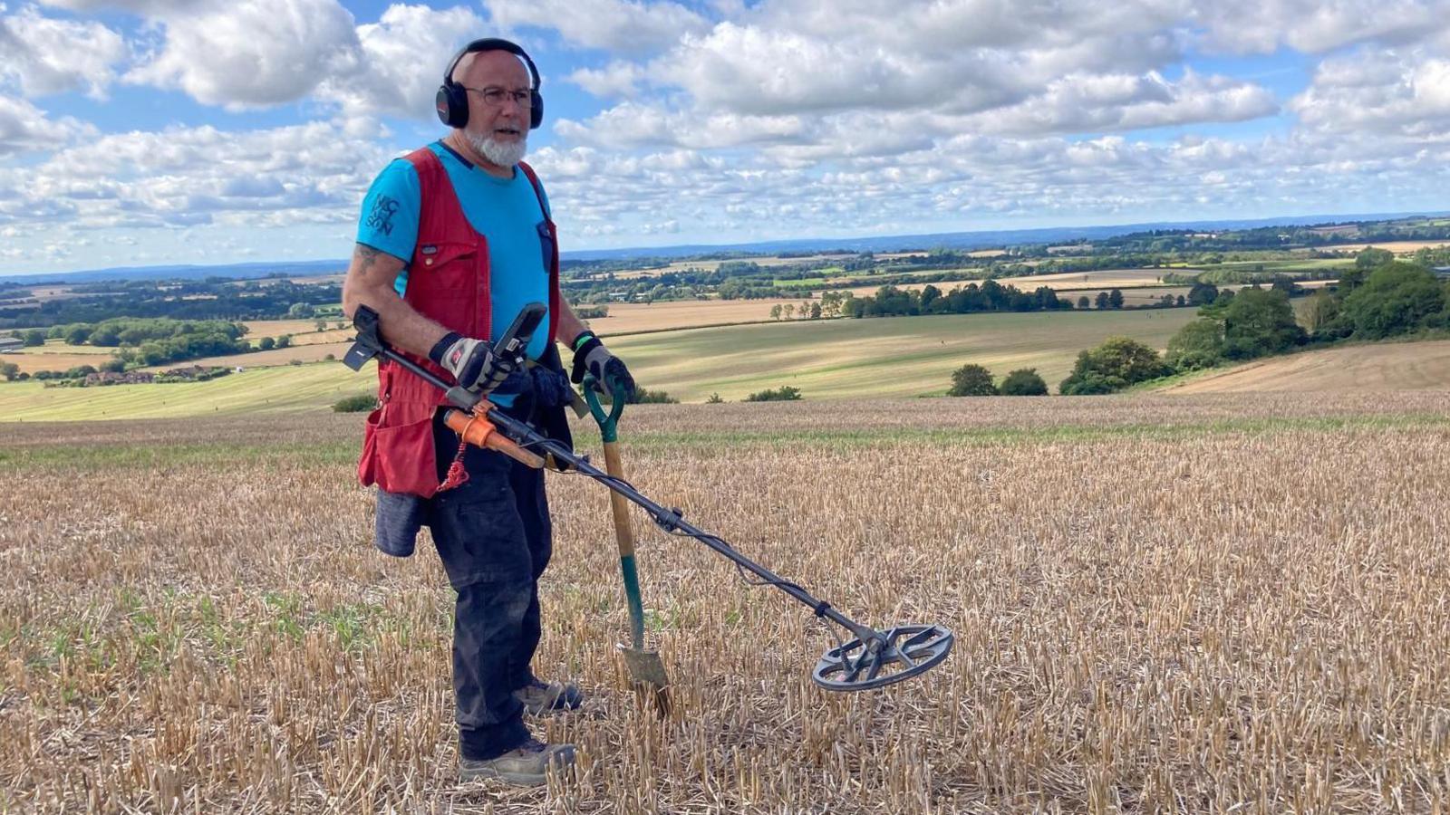 Paul Capewell with metal detector in field