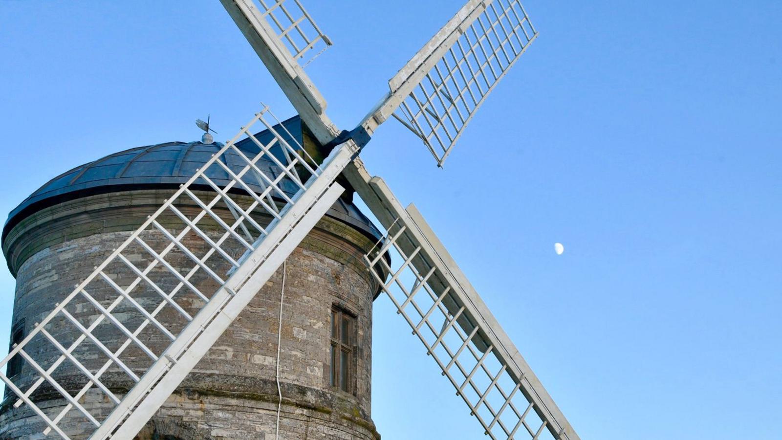 A photograph of Chesterton Windmill with four white sails.