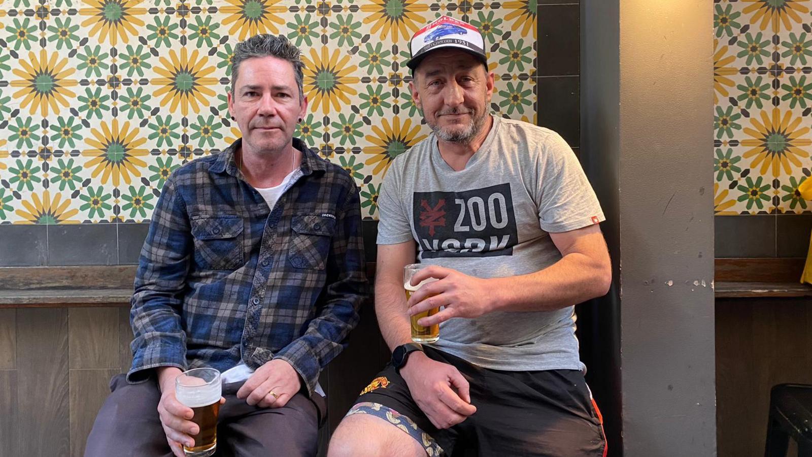 Jack Berman and an unnamed friend hold beers in the smoking section of a pub in Sydney. 30/8/2024