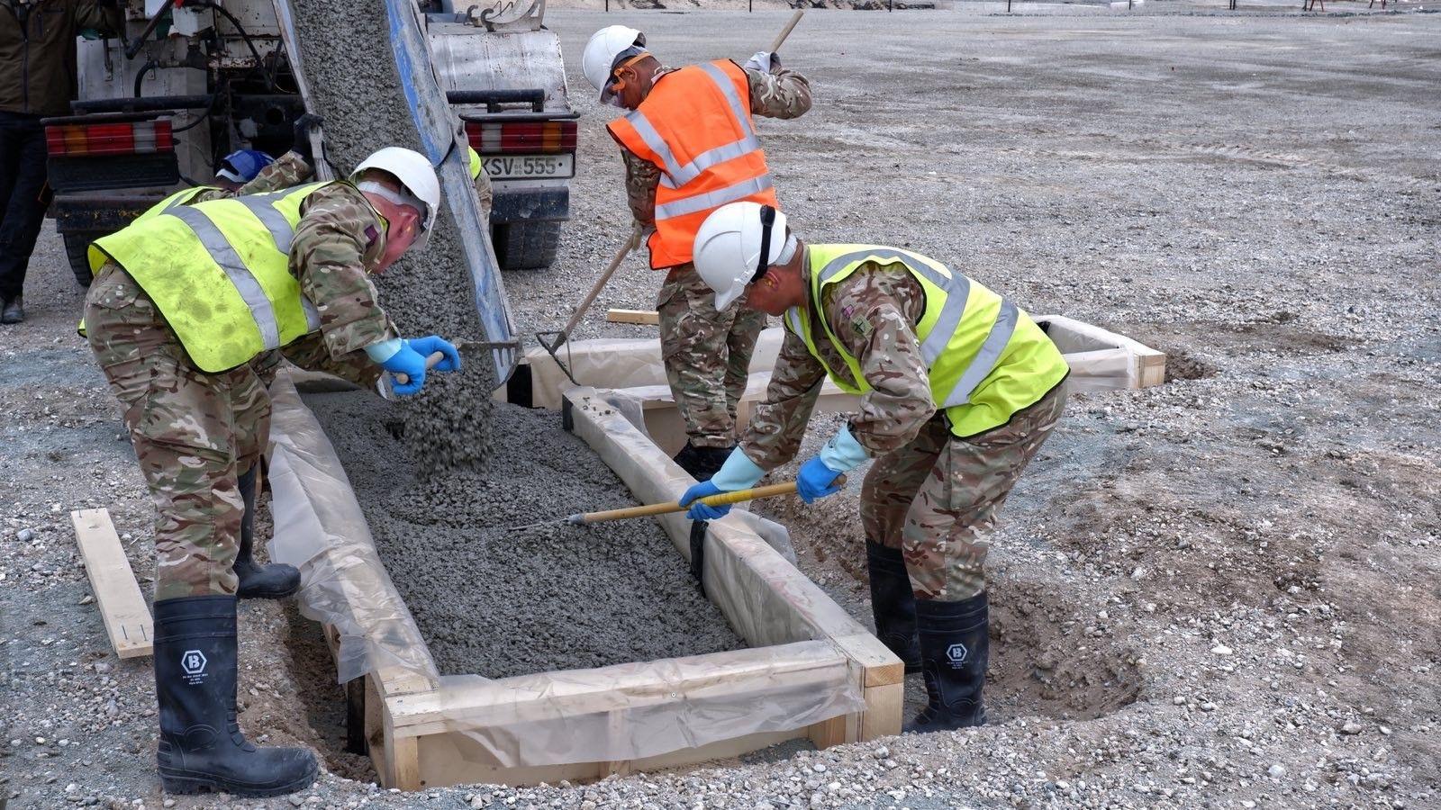 Construction work on Gigha helipad - workers laying cement