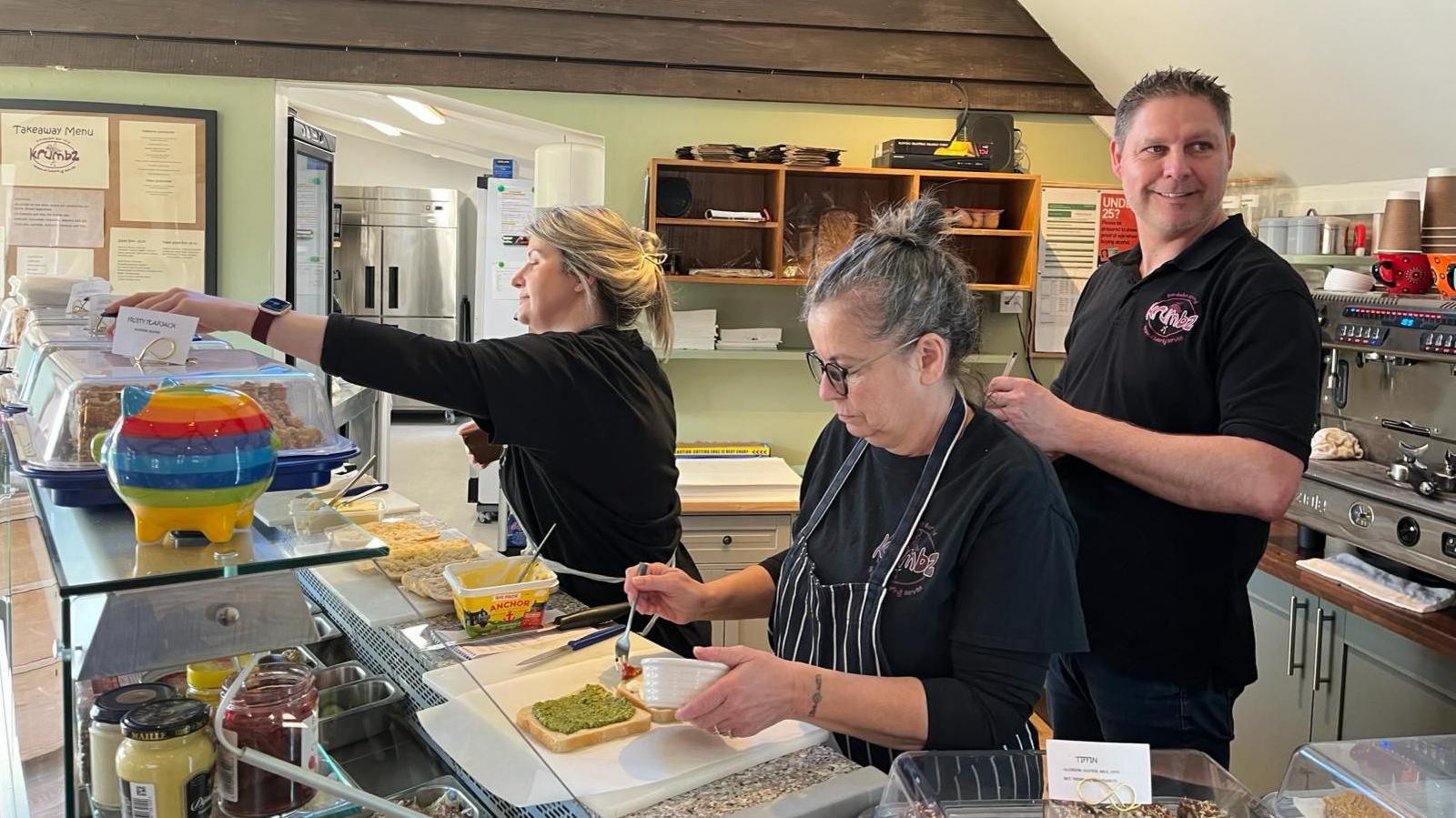 Counter staff serving at the cafe