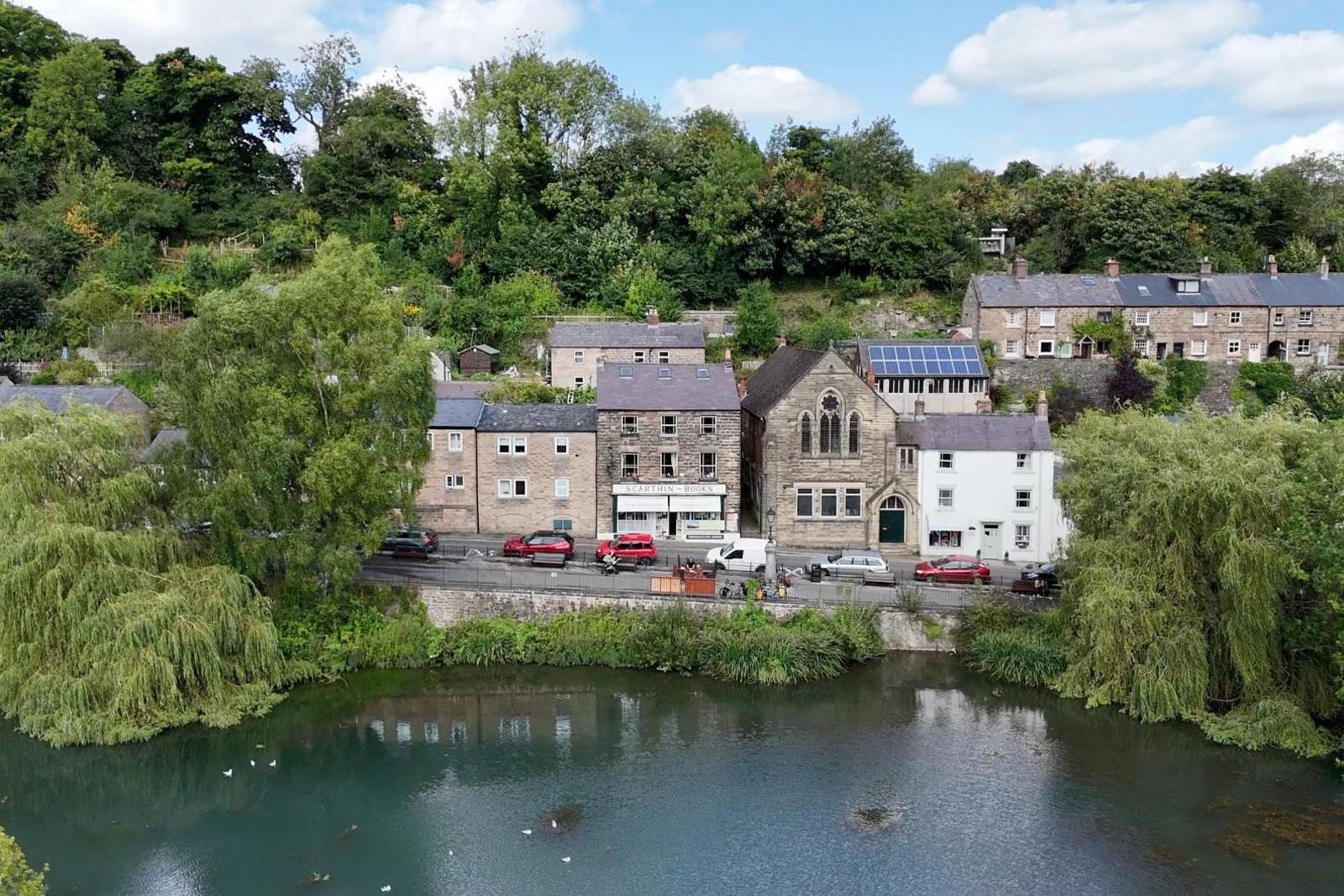 Cromford Mill Pond with buildings in background